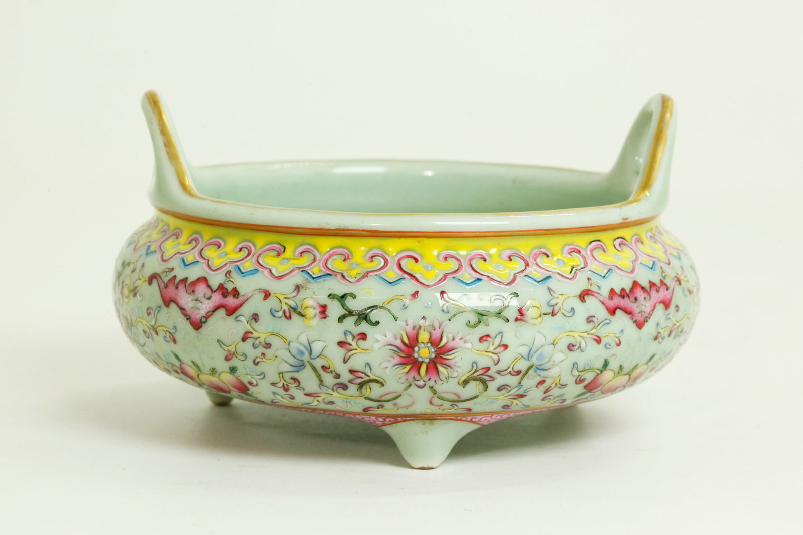 Chinese Gilt & Enameled Celadon Porcelain Censer: Chinese Gilt & Enameled Celadon Porcelain Censer on 3 feet with a pair of raised loop handles at the mouth edge, the sides with Famille Rose scrolling flowers between 4 descending Bats each holding 3