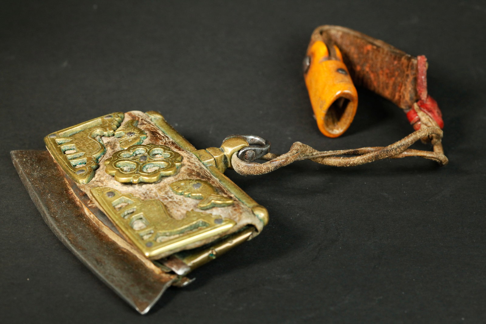 Tibetan Antique Bronze Steel Mecha Flint Striker: Tibetan Antique Steel Mecha Flint Fire Striker with a bronze edged leather pocket for flints and a cover decorated with bronze Deer, Fish and a 4-heart shaped disc, with swivel loop at top to attach t