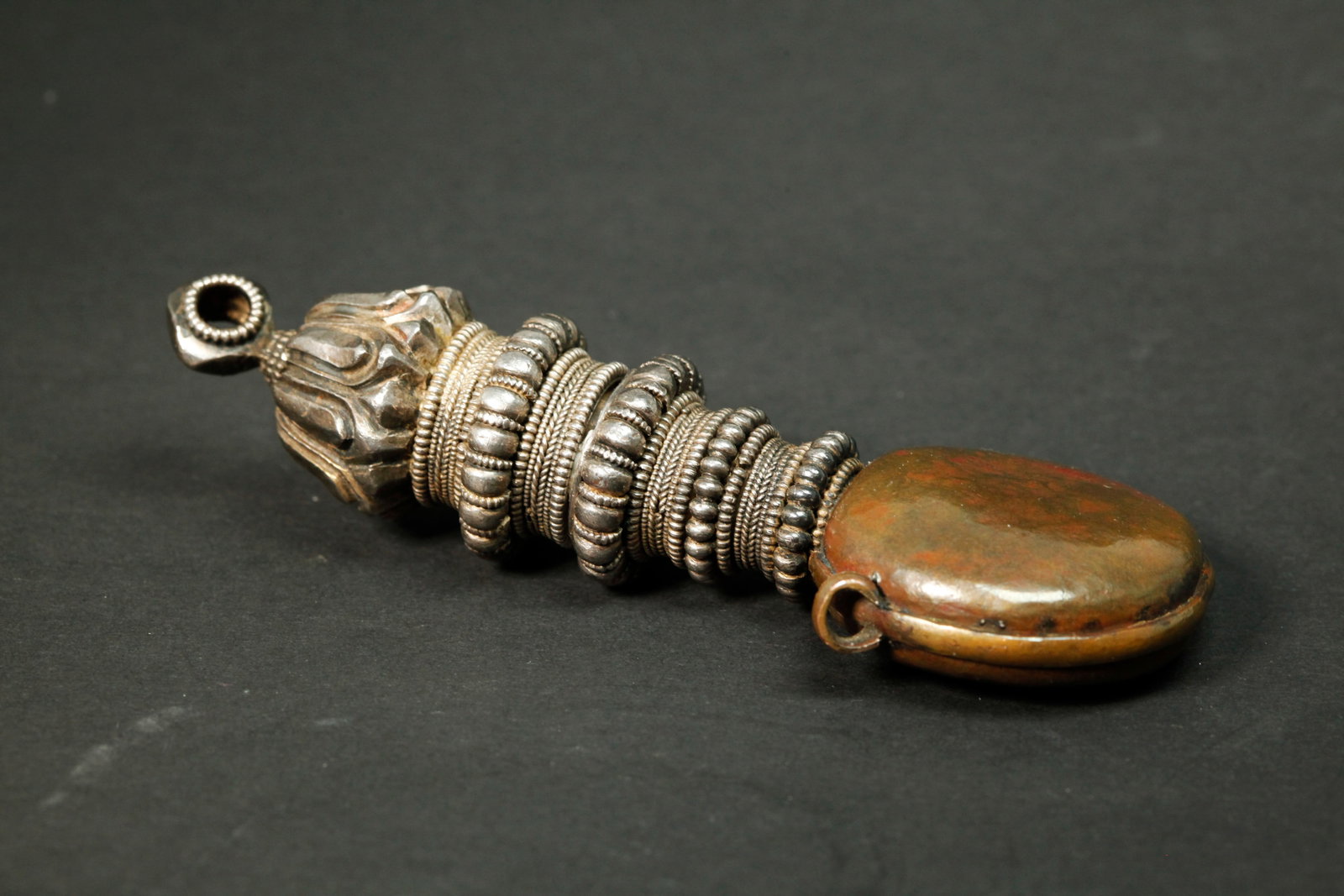 Tibetan Bronze Snuff Bottle Large Silver Stopper: Tibetan Bronze flattened round Snuff Bottle with 2 suspension loops to side edge and fitted with elaborate bands of silver beads & twisted wire to neck and base of stopper with Buddhist Lotus finial w