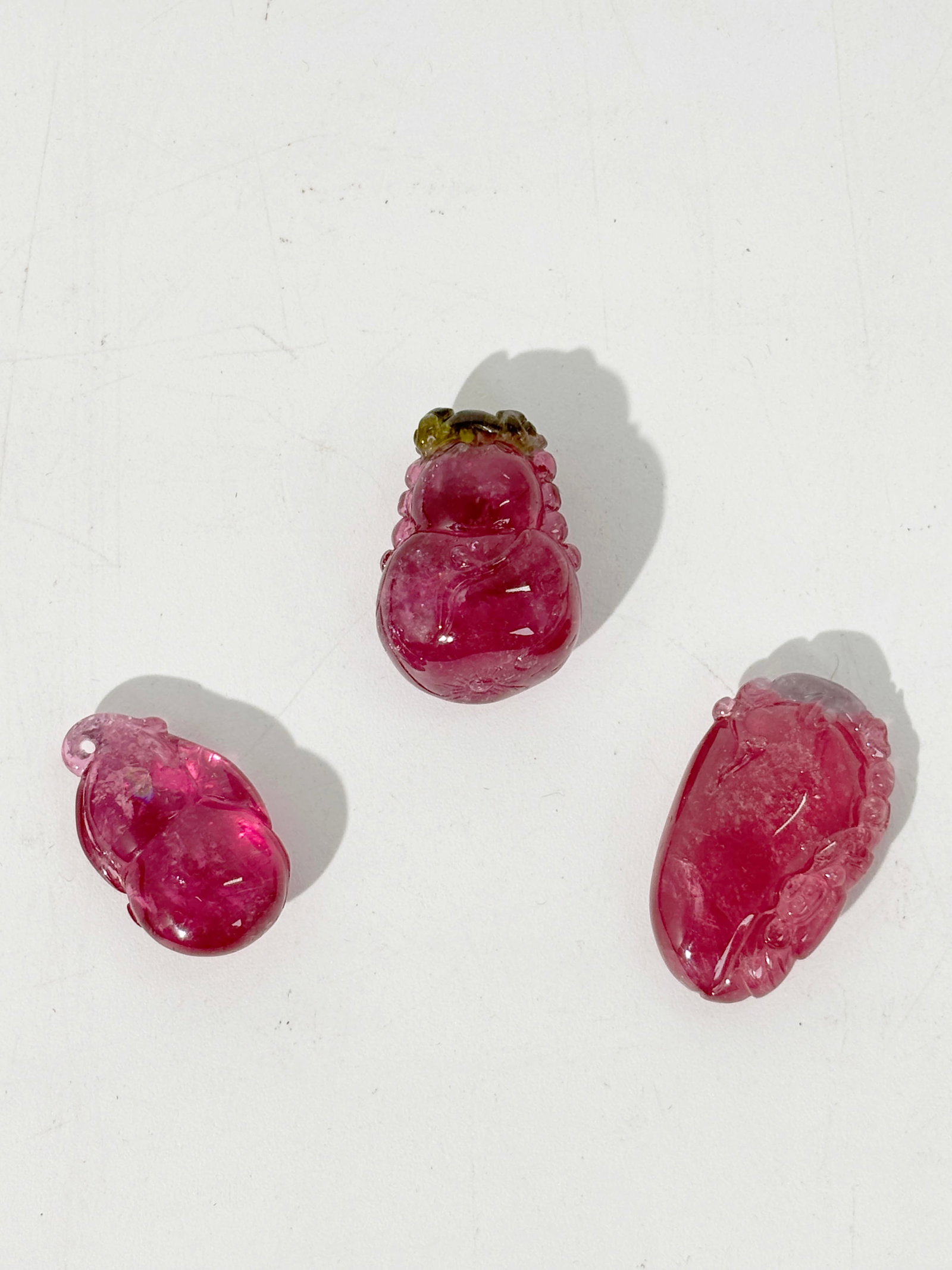 3 Fine Chinese Pink Tourmaline Pendants: 3 Fine Chinese Pink Tourmaline Pendants: the largest a watermelon tourmaline double gourd with green lingzhi at top with hole; a bright pink fruit & Bat with slightly whitened top with hole and a smal
