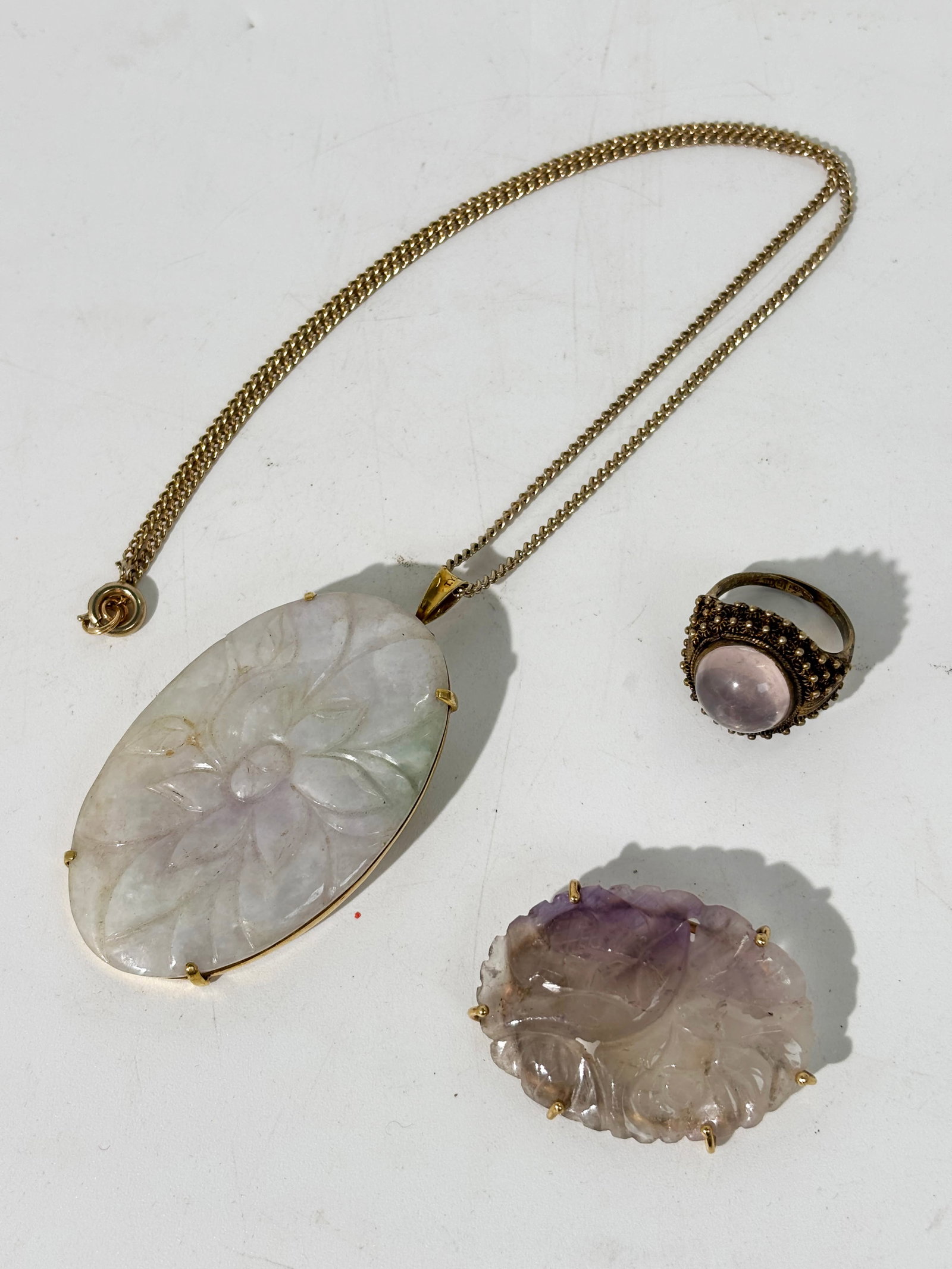 3 Pc Chinese Jadeite Pendant Amethyst Pin & Ring: 3 Pieces: Chinese white translucent Jadeite with slight pale green & pale lavender inclusions carved as a Lotus oval with a flat back in a yellow gold setting with safety pin and hinged loop for suspe