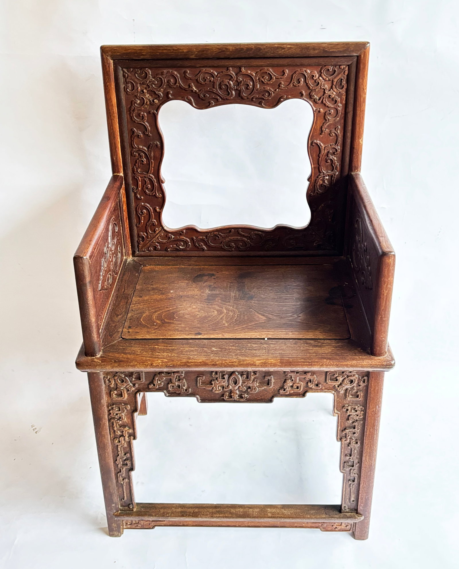 Chinese Hard Wood Carved Bracket Panel Arm Chair: Chinese Hard Wood Carved Bracket Panel Arm Chair with carved brackets reinforcing the 4 legs and back sides and top; the arms with full carved panel inserts; with panel seat a foot rest cross bar to f