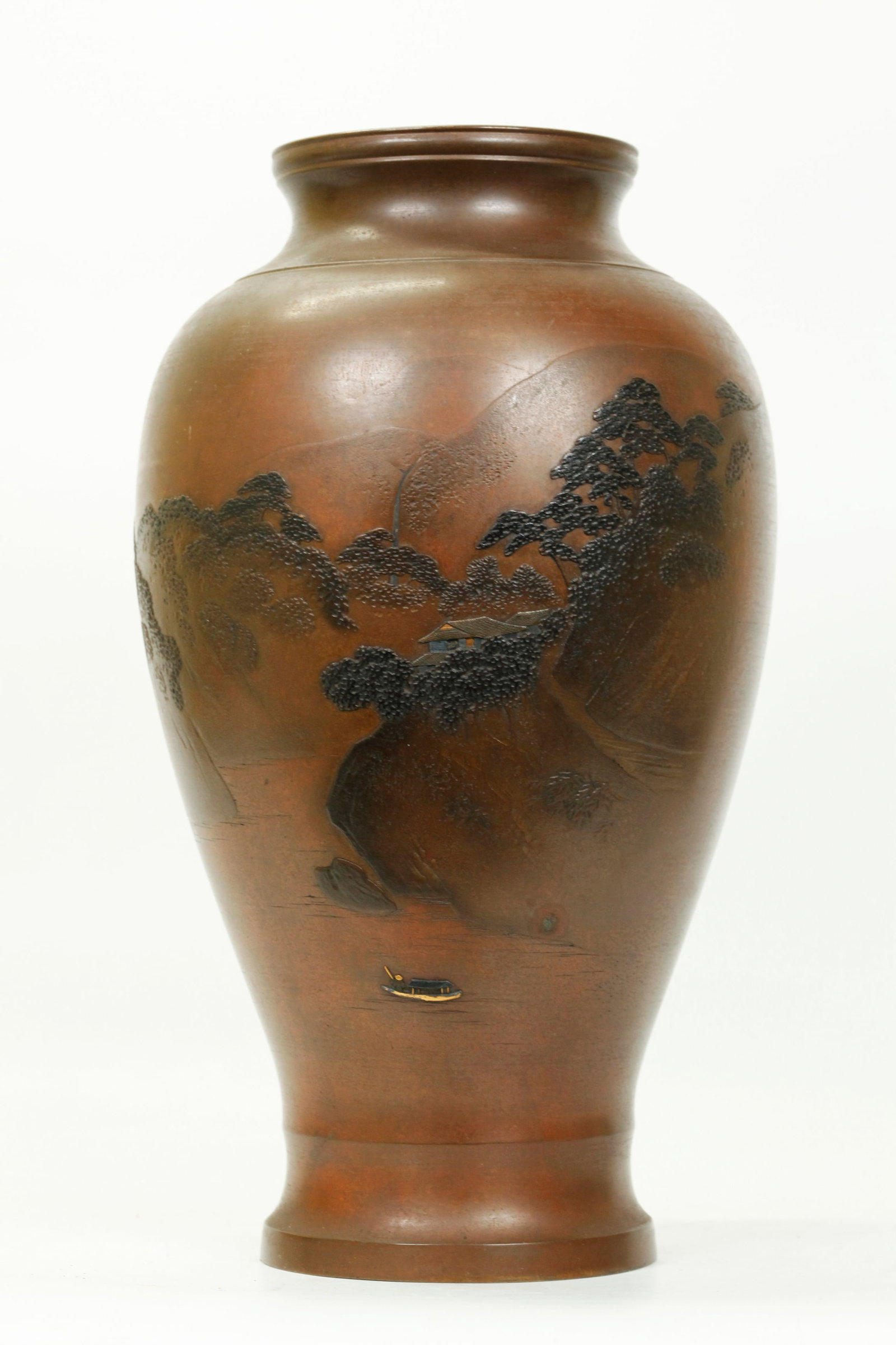 Fine Japanese Mixed Metals on Bronze Vase: Fine Japanese Mixed Metals on Bronze Vase with an inlaid design of a Boat and House in gold & silver on an incised view of a River Gorge; the ground patina in greenish brown. Height 12 inches x Diamet