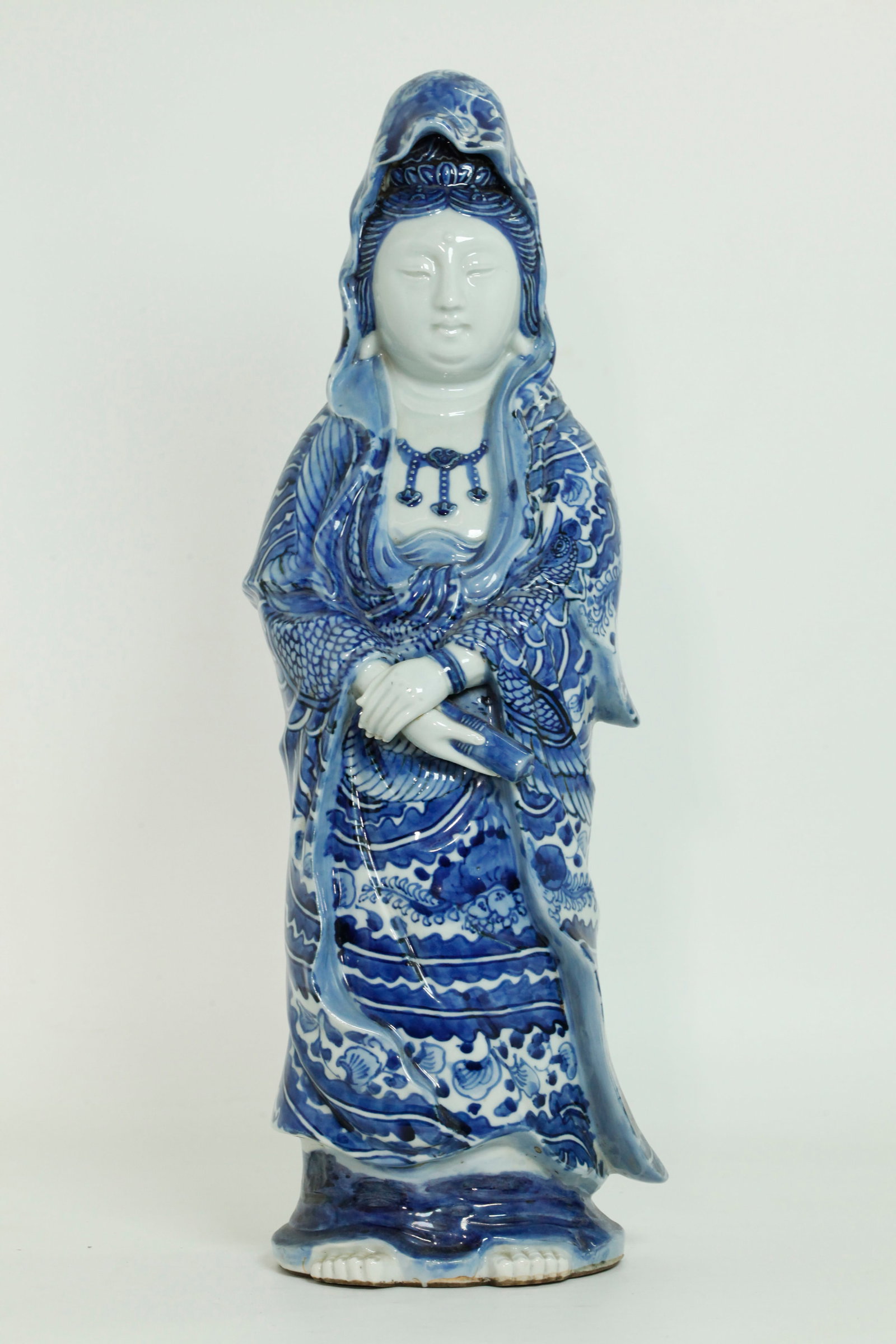 Japanese Meiji Arita Blue White Porcelain Guanyin: Japanese Meiji Period Arita Blue & White Porcelain standing Guanyin holding a scroll in her right hand, her robes elaborately painted in underglaze blue with large Ho-o Birds and large Flowers, her fa