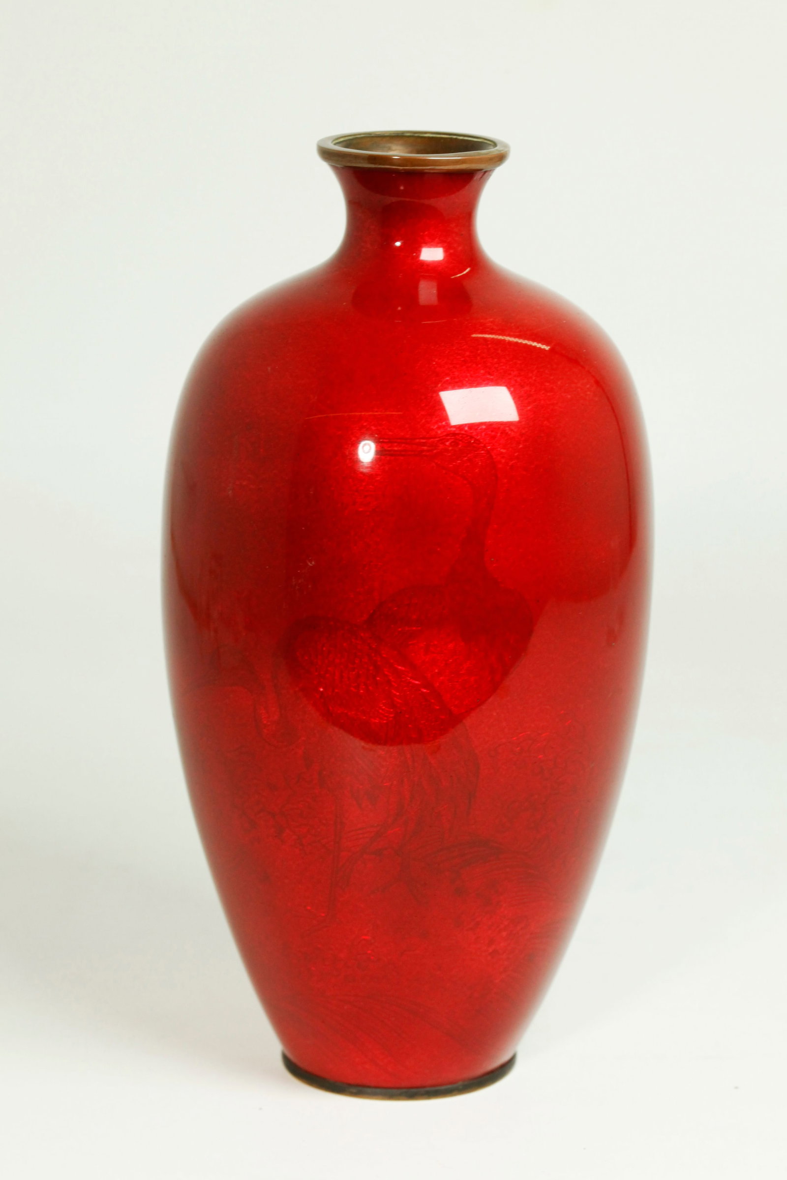 Japanese Meiji Transparent Red Crane & Wave Vase: Japanese Meiji Period Transparent Pinkish Red polished enamel over a bronze vase well incised with a design of 2 Cranes on a Rock among splashing waves. Height 9 1/4 inches X diameter 4 1/4 inches.