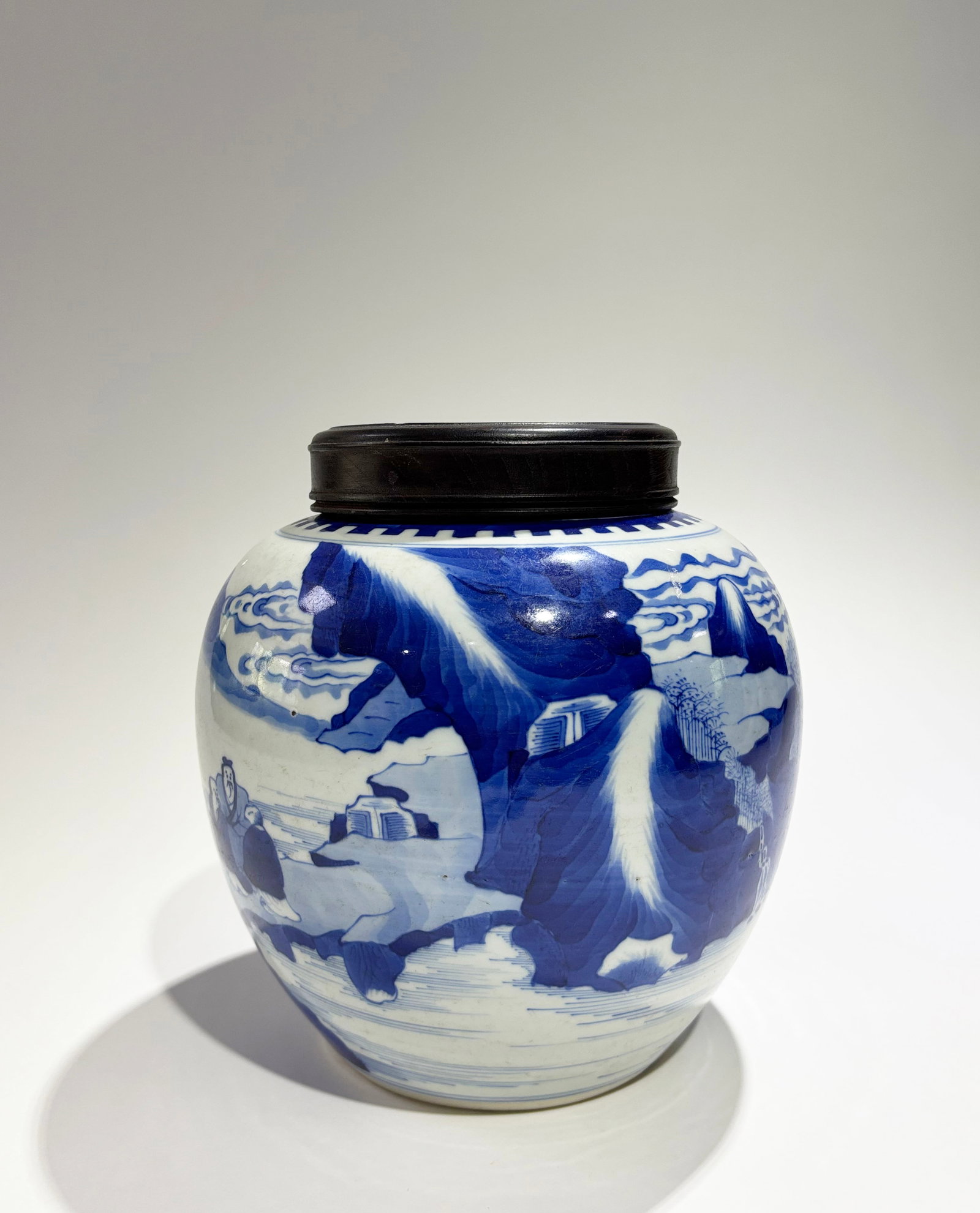 Chinese Blue & White Porcelain Scholars Ginger Jar: Chinese Blue & White Porcelain Scholars on a rock bridge in Landscape Ginger or Tea Jar, a crenellated border around the unglazed mouth, the recessed base in clear glaze; with wood cover. Height 8 1/4