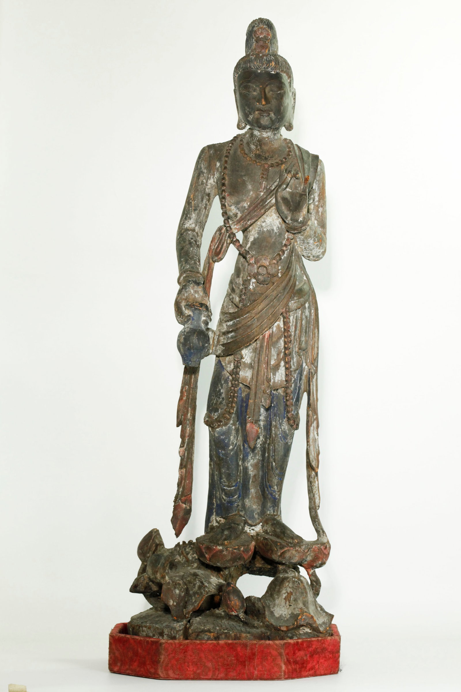 Lg Chinese Carved Wood Avalokiteshvara Guanyin: Large Chinese Carved Wood Avalokiteshvara Guanyin holding a vase of compassion and standing with each foot on a Lotus blossom rising from stems with Lotus leaves and buds forming the base; the figure 