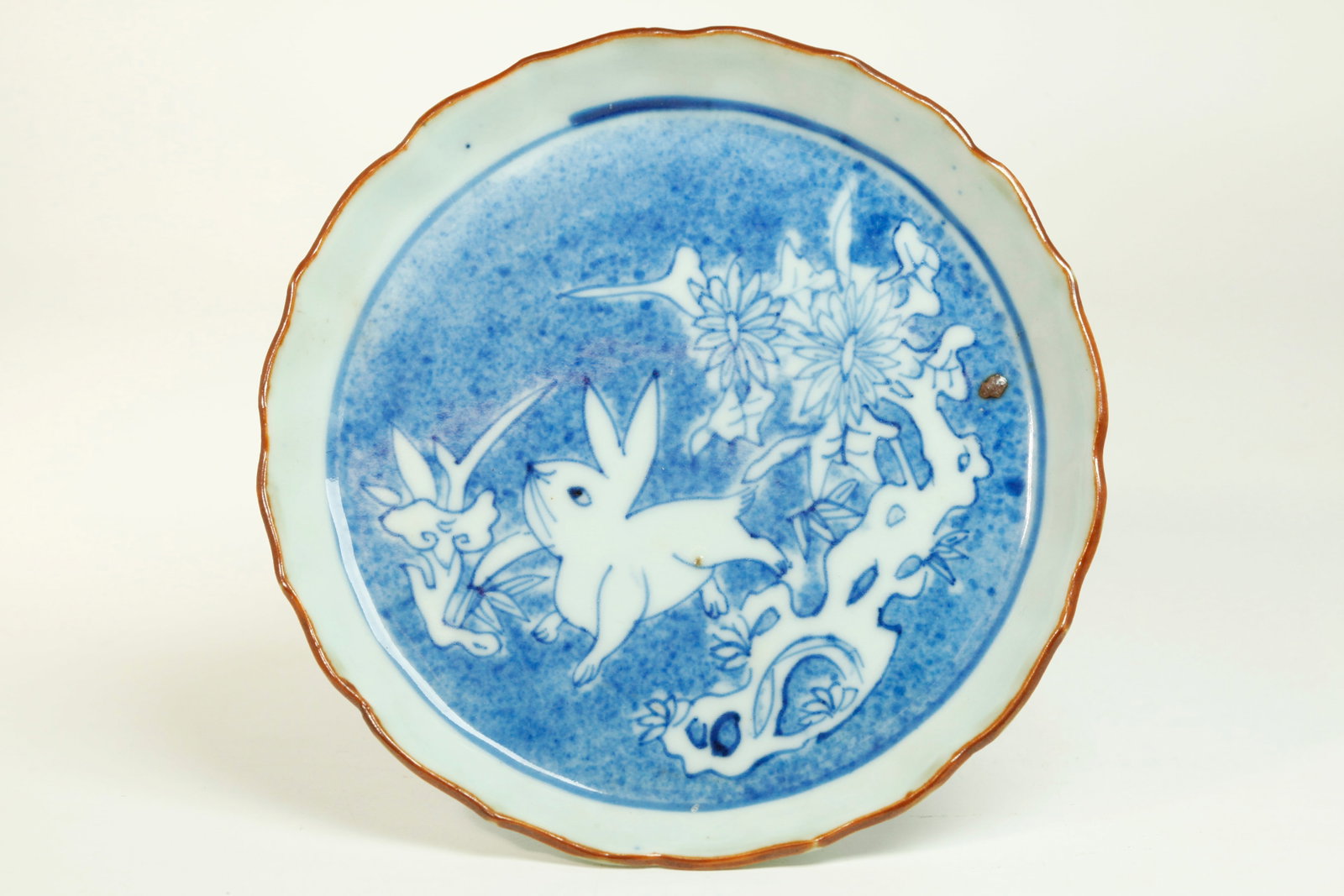 Rare Chinese 17C Kosometsuke Blue White Porcelain: Rare Chinese 17th Century "Ko-sometsuke" Blue & White Porcelain small plate, Tianqi Period, with Rabbit, Lingzhi, Garden Rock & Flowers in clear glaze on a blue sprayed ground, inside a fluted edge wi