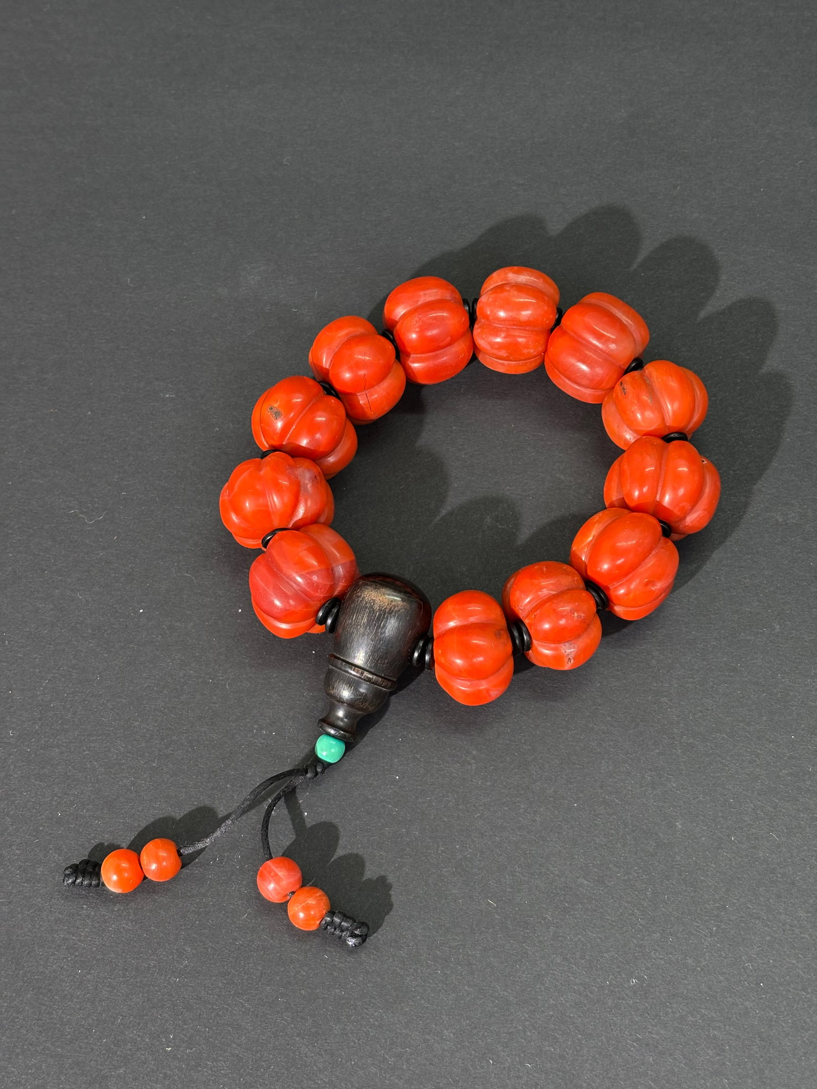 Chinese 12 Carnelian "Melon" Fluted Bead Bracelet: Chinese 12 Carnelian "Melon" Fluted Bead Bracelet with turned buffalo horn head-bead and small blackspacer beads. Length 9 inches. Total weight 178.3 grams.