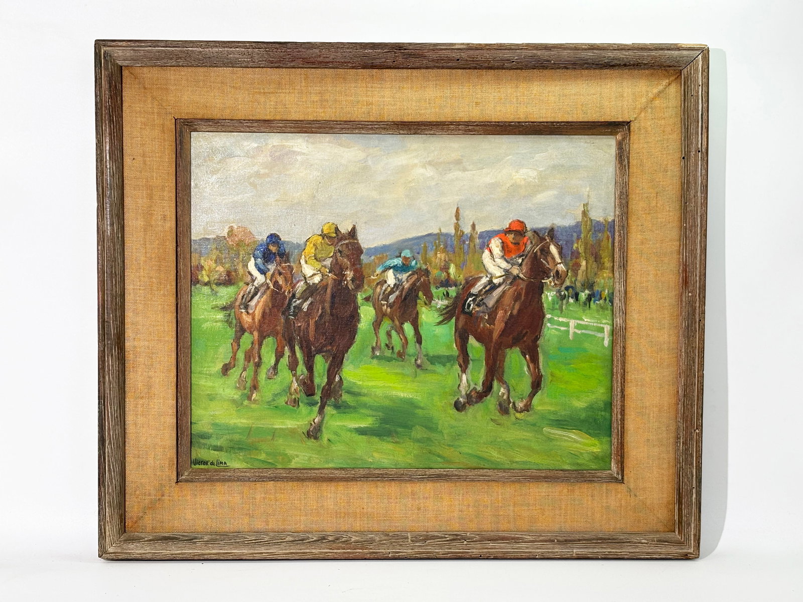 Victor de Lima: Oil Canvas Race Horse Image: Oil on Canvas on stretcher signed "Victor de Lima" of 4 Race Horses and Jockeys on a Grass Track with low white fencing and a view of mountains in the distance; framed in driftwood with canvas matting