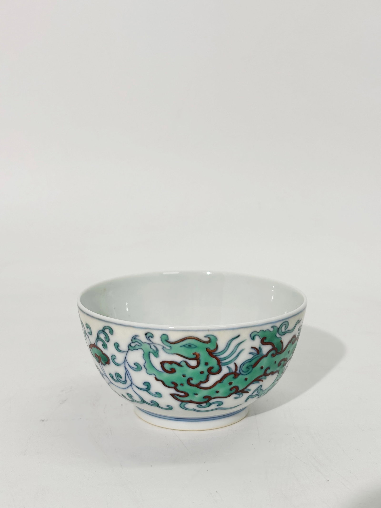 Chinese Doucai Enamel Porcelain Chilong Cup: Chinese Doucai Enamel Porcelain Chilong Cup with 2 archaistic chilongs and Lingzhi to outside, the inside with an archaistic Phoenix roundel, the base with 6 character Qianlong seal mark in underglaze