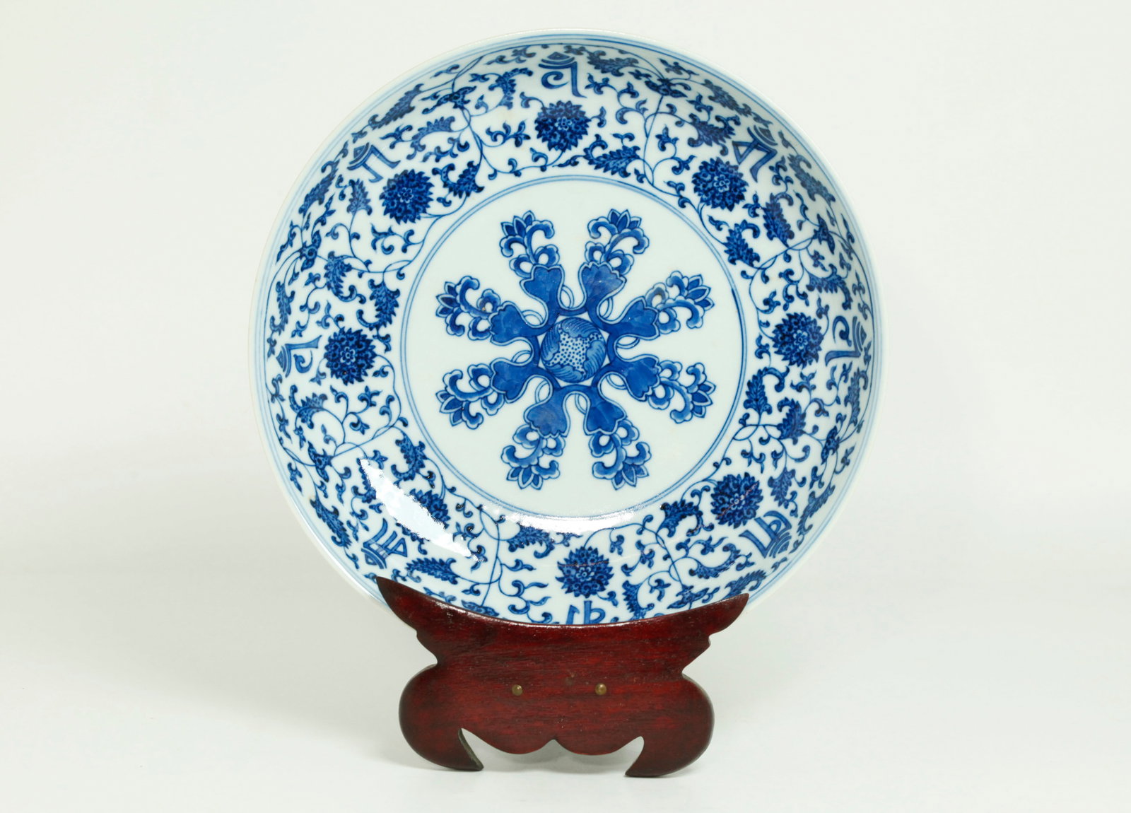 Lg Chinese Blue & White Buddhist Porcelain Plate: Large Chinese Blue & White Porcelain Plate well painted in Ming Style "heaped & piled" effect with 8 point Buddhist flower center and a border of 8 scrolling Lotus and 8 Tibetan script characters, the