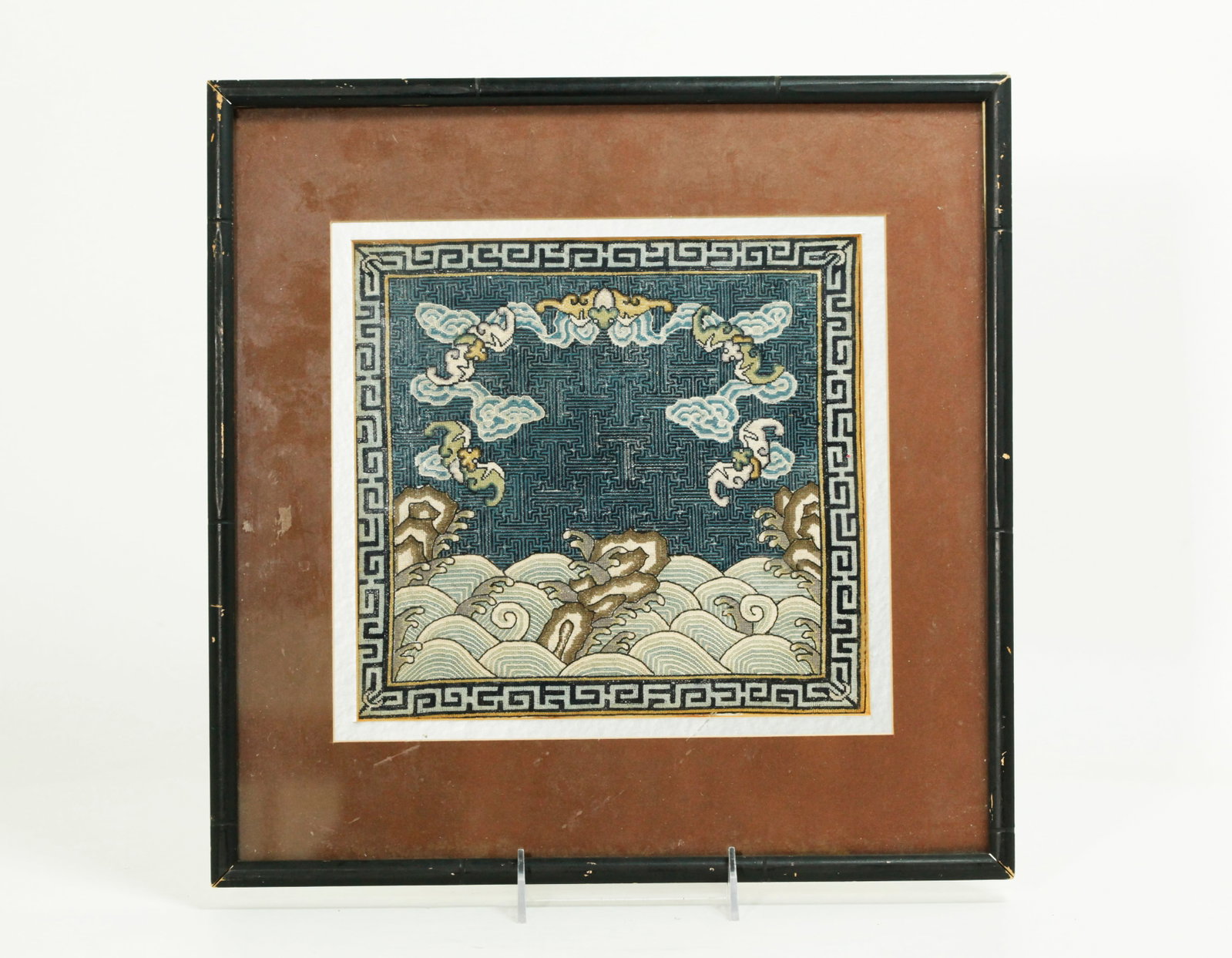 Chinese Qing Dynasty Unused Silk Rank Badge: Chinese Qing Dynasty solid Unused Silk Rank Badge in tent-stitch with 5 bats in clouds on a trellis ground over waves & rocks with a center figure and Sun to be applied later; matted and framed. The f