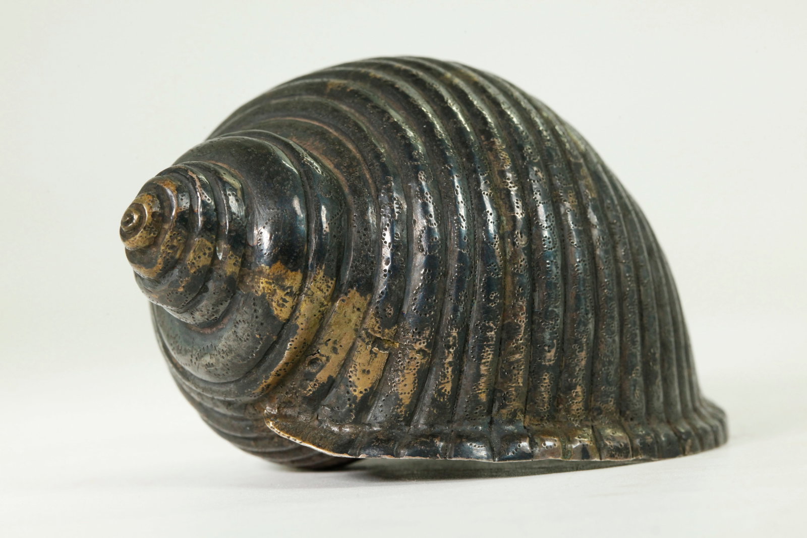 Fine Chinese / Tibetan Silvered Bronze Conch Shell: Fine Chinese / Tibetan Hand-Hammered & Silvered Bronze Ritual Conch Shell elegantly fluted and dot-stamped with curls to the flutes. Height 2 1/4 inches X width 4 3/4 inches.