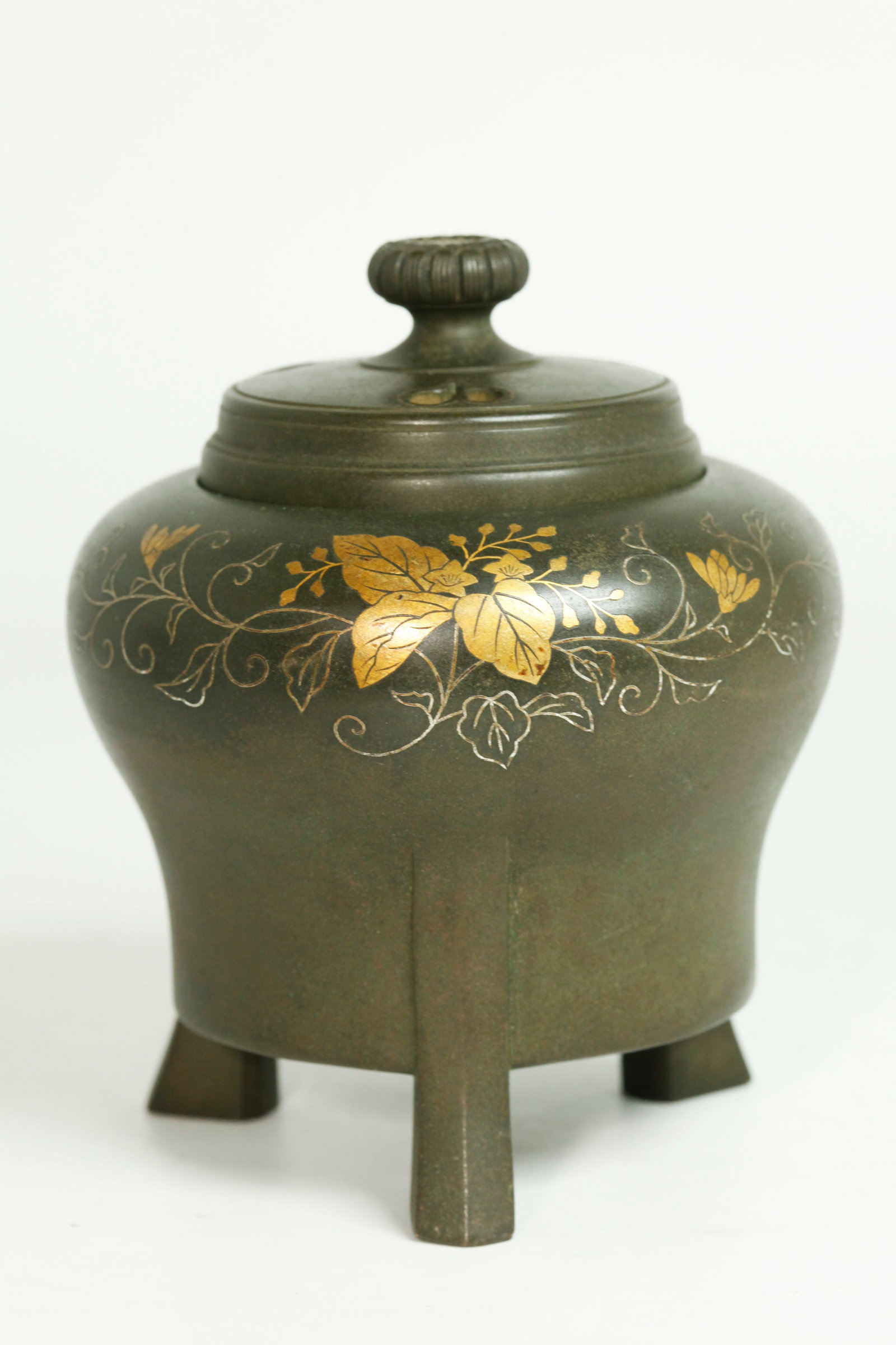 Japanese Gold & Silver On Bronze Censer & Cover: Japanese Gold & Silver inlay on heavy Bronze Censer in a greenish-brown patina; on 3 flared feet with a design of leaves, tendrils, small flowers around the shoulders with a bronze Cover with 3 pierci