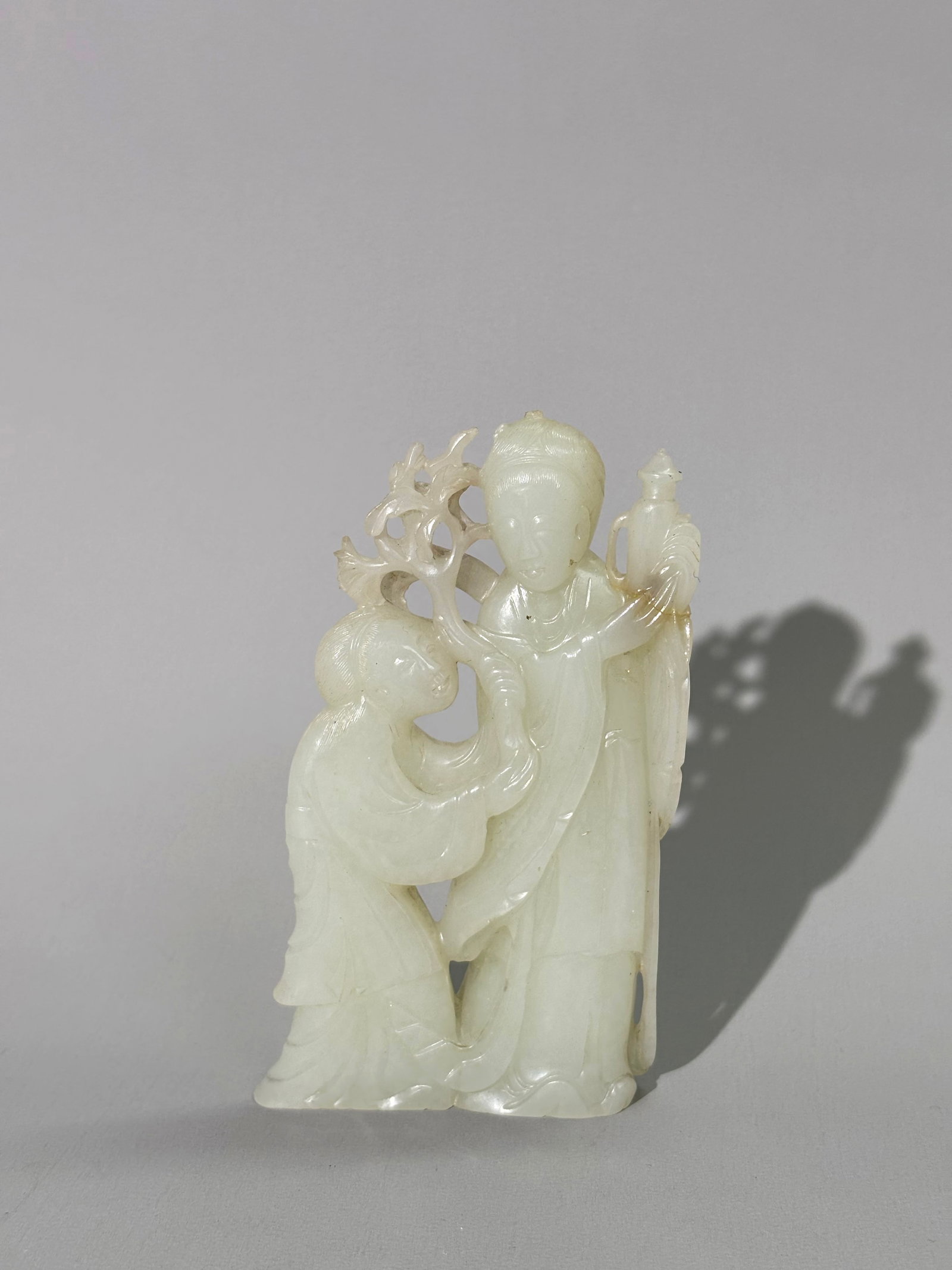 Chinese 18th C White Jade Carving 2 Ladies: Chinese 18th Century translucent White Jade Carving of a Lady standing with a Wine Pot, her assistant carries a leafy branch; with fine details to th hair of each. Height 4 1/2 inches X width 2 3/4 in