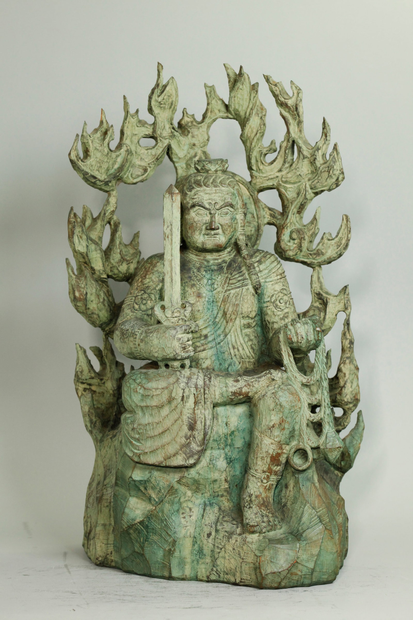 Fine Lg Japanese Carved Wood Fudo Myo-o Figure: Fine Large Japanese Carved Wood Fudo Myo-o Buddhist Figure seated on immovable rock with wisdom sword & temptation rope surrounded by purifying flames with 3 character incised inscription to back of r