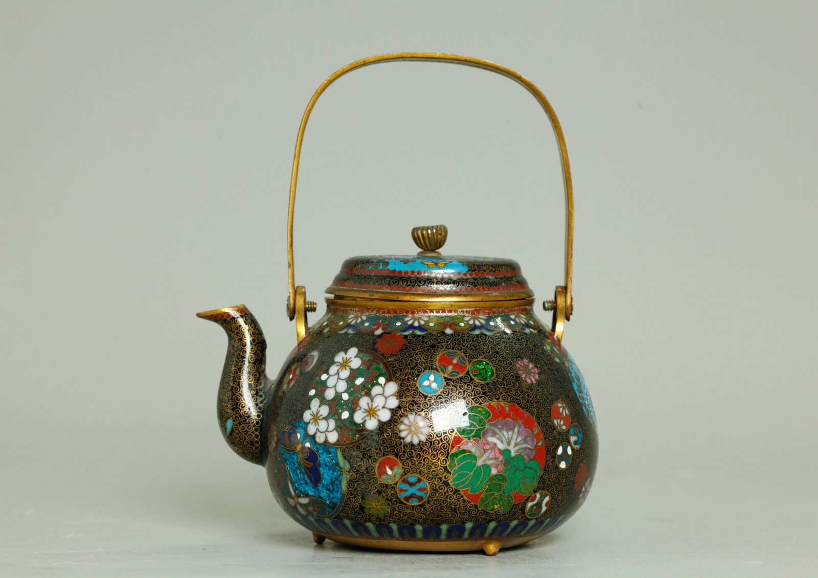 Japanese Meiji Gilt Bronze & Cloisonne Teapot: Japanese Meiji Period Gilt Bronze & Cloisonne Teapot, the sides and cover with butterfly, fruit and flower roundels, large and small, on a black enamel ground with curled wires, some of the roundels w