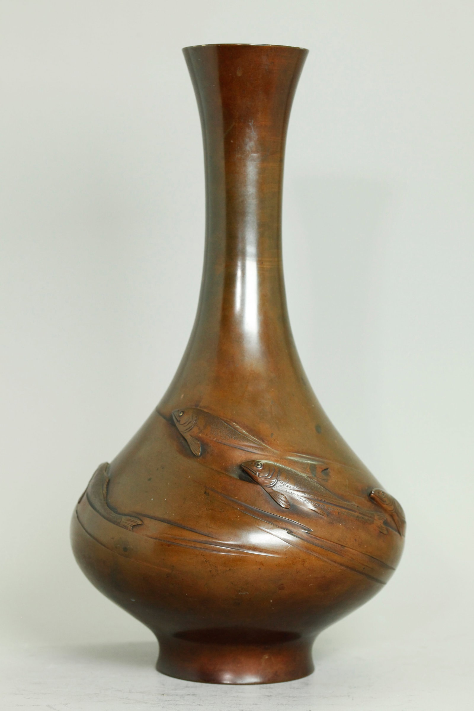 Fine Japanese Meiji Bronze Ikebana Fish Vase: Fine Japanese Meiji Period Bronze Ikebana Fish Vase with the bulbous base molded and carved with small fish swimming around the outside each inset with black and gold wire eyes; the base with a cast c