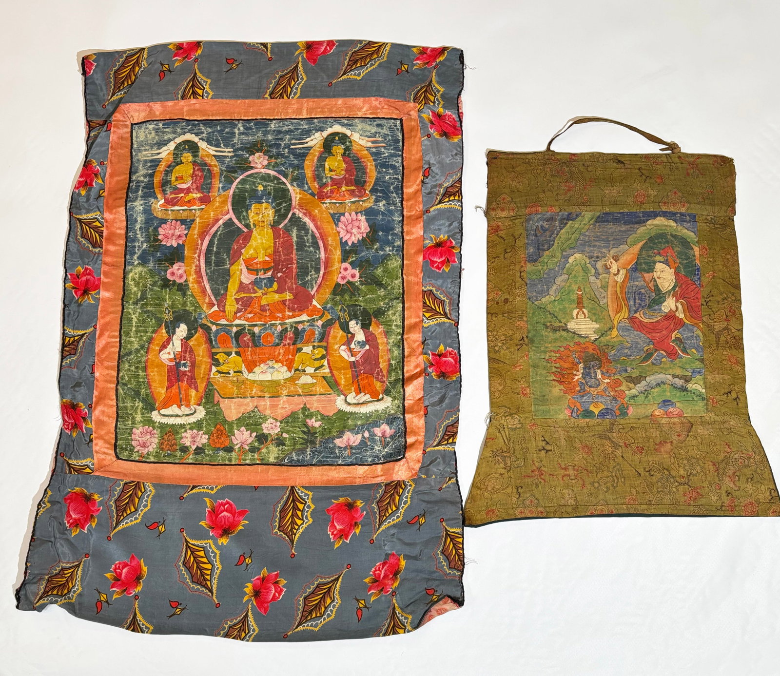 2 Tibetan 19th Century Thangkas: 2 Tibetan 19th Century Thangkas, the larger with a "Healing Buddha" with bowl and the smaller with Lama, Stupa and Blue Tara; each mounted on antique or vintage fabric for travelling. Height of larger