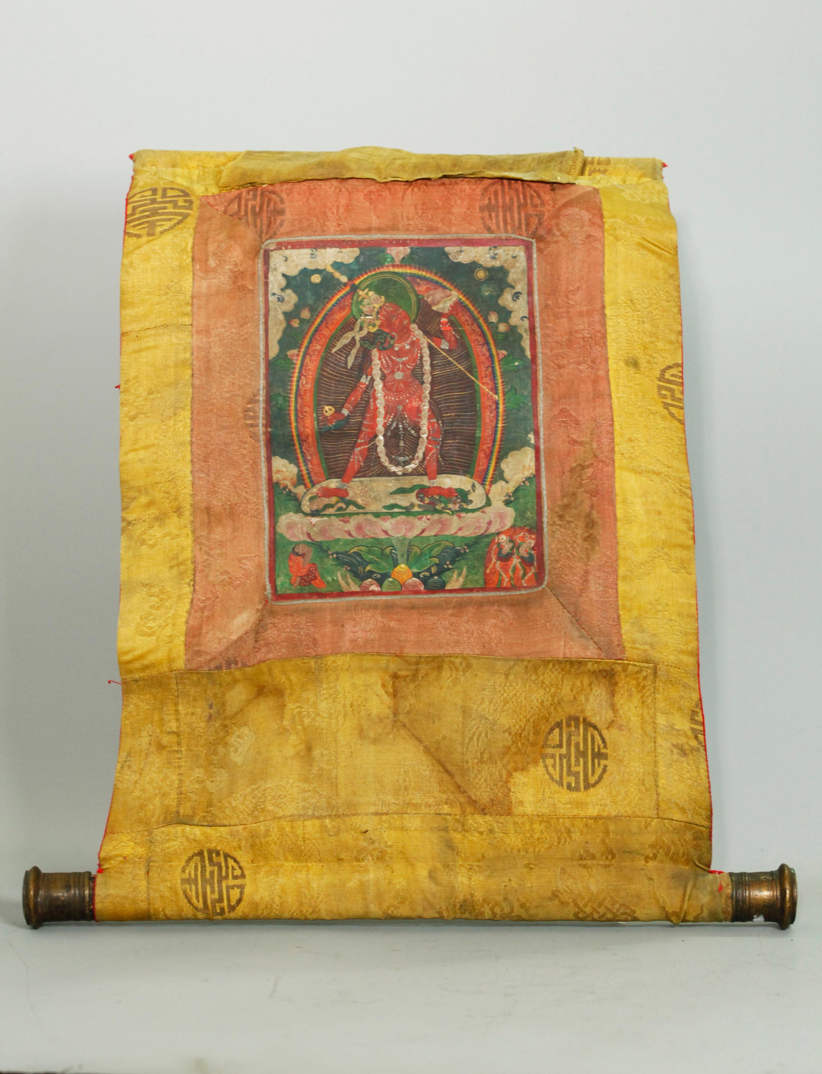 Tibetan Thangka of Vajrayogini,19th Century: Thangka of Vajrayogini, Tibet, 19th Century; The central depiction shows the fierce red-bodied Vajrayogini standing in alidhasana atop a lotus, holding a kapala skull cup and curved knife, adorned wit