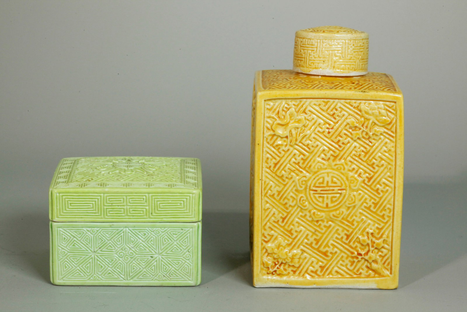 2 Chinese Qing Molded Porcelains; Box & Tea Caddy: 2 Chinese Qing Dynasty Molded Biscuit Porcelains; a square Box & cover with trellis patterns and 5 Bats & Shou medallion to top all covered in lime green glaze with turquoise glaze to inside; together
