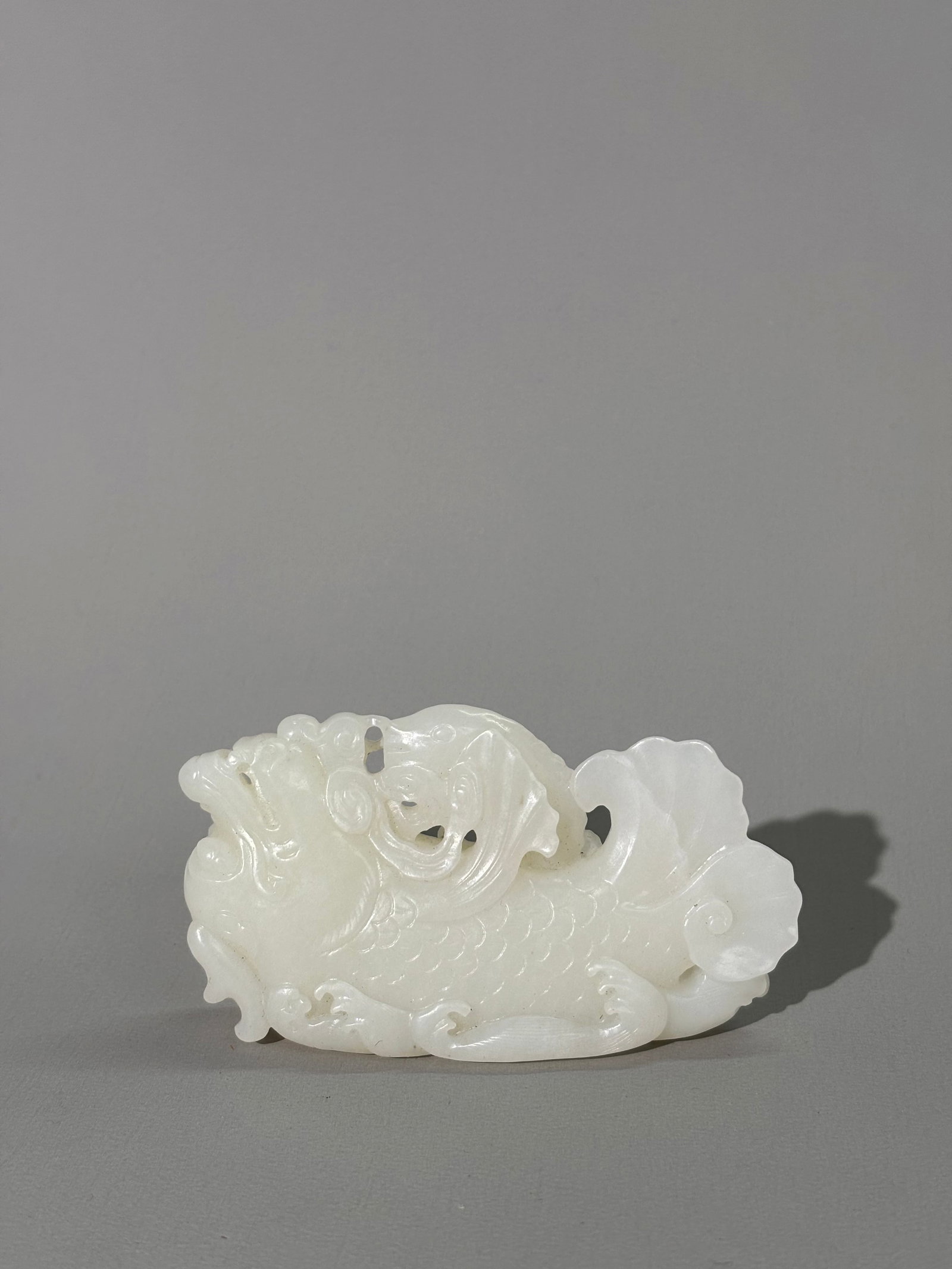 Chinese White Jade Dragon Fish & Leaping Carp: Chinese Translucent White Jade Dragon Fish & Leaping Carp, carved, pierced & polished with fine details, the flattened base carved with lines as water waves. Width 3 1/2 inches X height 1 7/8 inches.