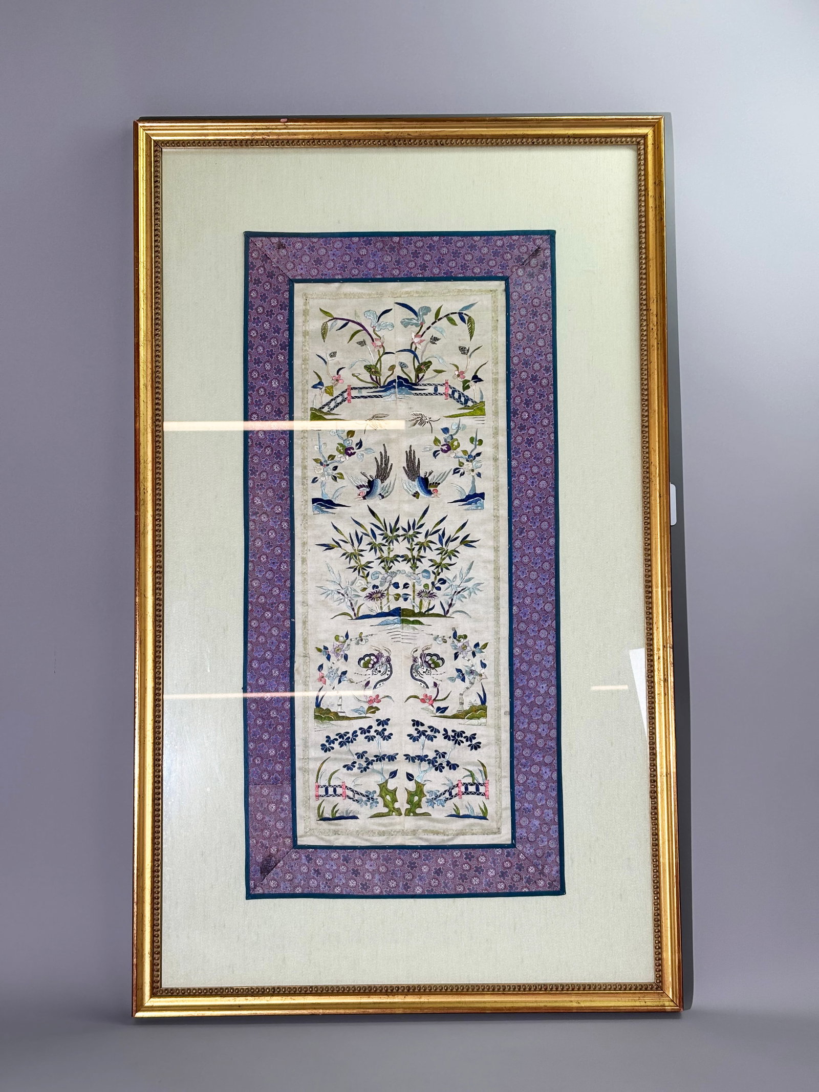 Pr Chinese Qing Embroidered Satin Sleeve Bands: Pair Chinese Qing Dynasty Embroidered Satin Sleeve ends finely decorated with Birds, Flowers, Bamboo, Lotus and Butterflies, now sewn together and trimmed with ribbons and brocade to form a mat, on a 