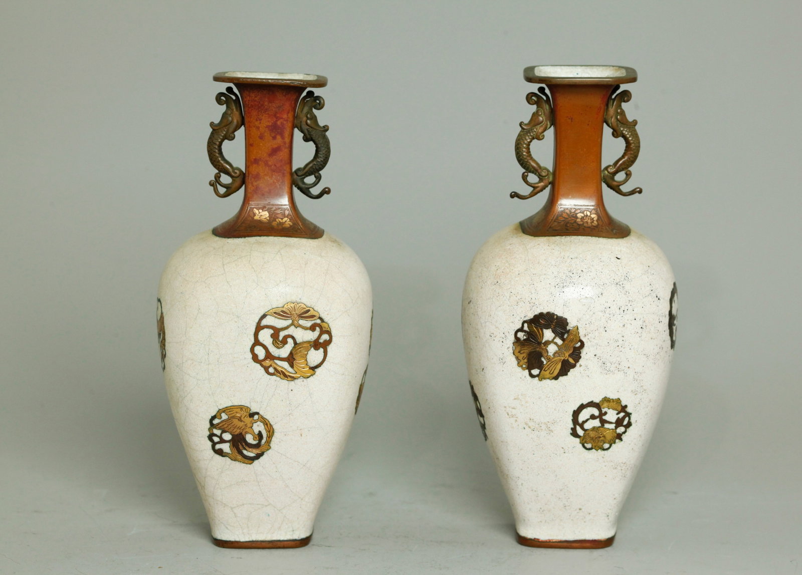 Pr Japanese Meiji Crackle Enamel Gilt Bronze Vases: Pair Japanese Meiji Period cream Crackle Enamel to bodies and inside of partially Gilt copper alloy Vases with fish handles to the necks, the polishing revealing small roundels to body of birds, butte