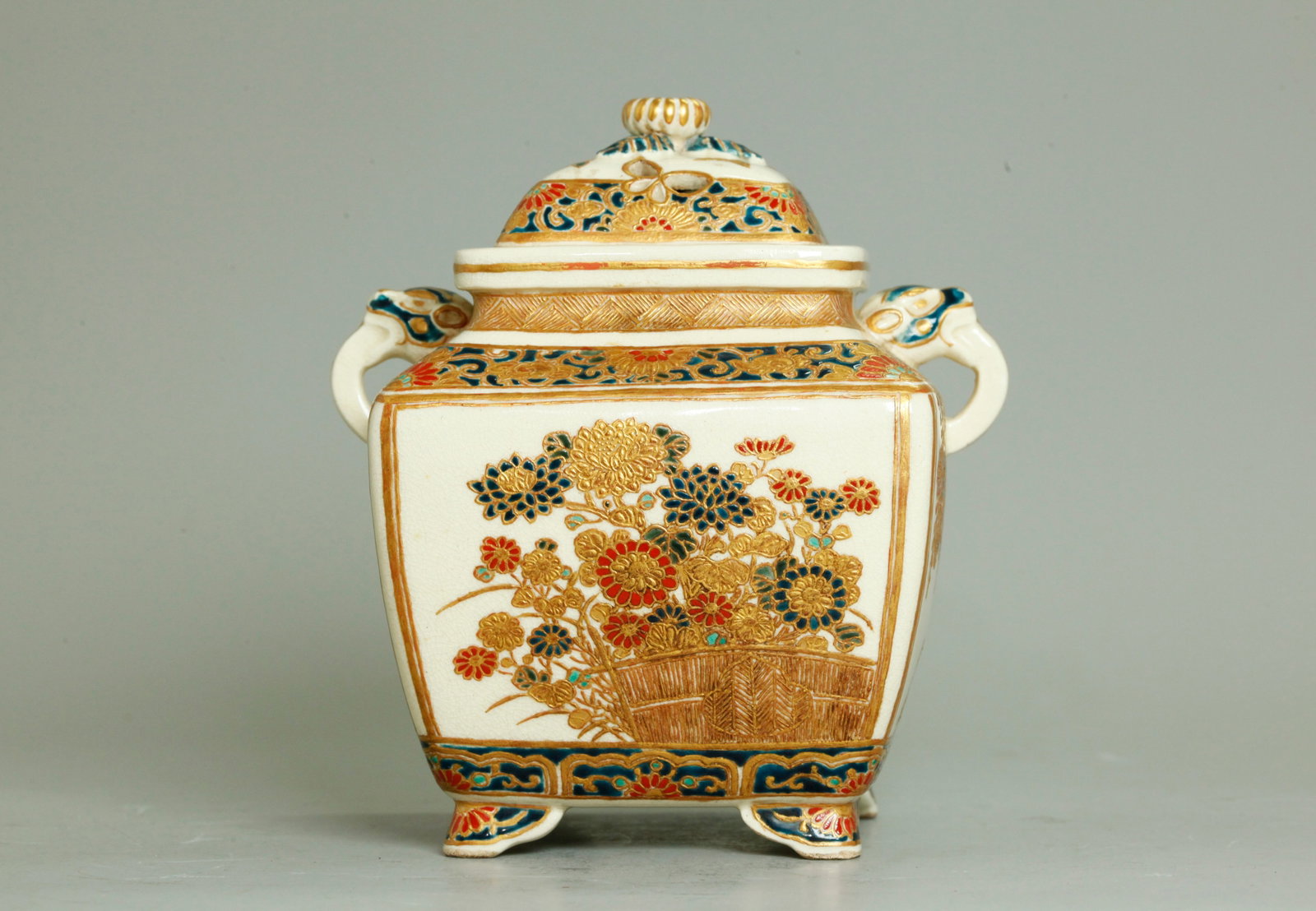 Japanese Meiji Satsuma 4 Sided Porcelain Censer: Japanese Meiji Satsuma 4 Sided crackle Porcelain Censer elaborately enameled with flowers to sides in colors and mostly raised gilding, with Animal Head & Tongue handles to the shoulders, on 4 small f