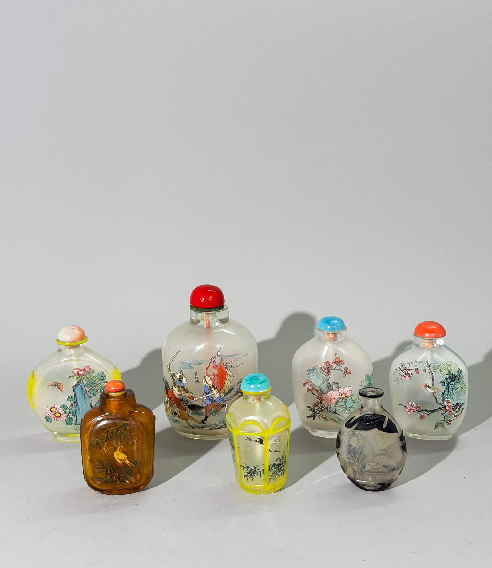 7 Chinese Inside Painted Glass Snuff Bottles: 7 Chinese Inside Painted Glass Snuff Bottles: the largest in clear glass well painted with military scenes of Soldiers on Horses; 2 clear glass bottles with beautiful landscapes to 1 side and Flowers 