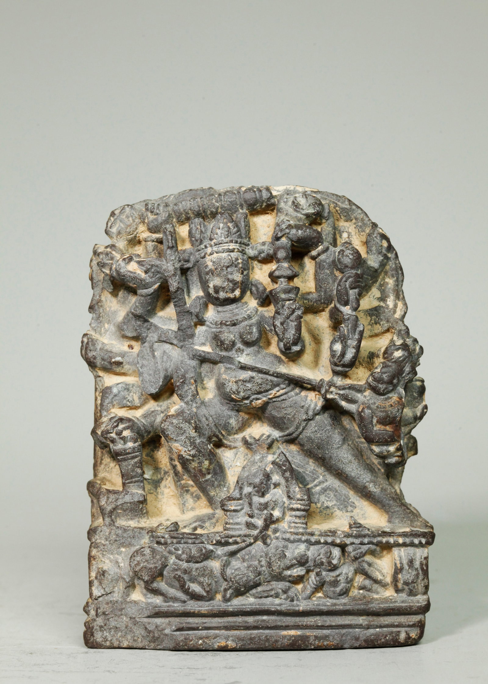 Sm Tibetan Black Stone Shri Devi Plaque: Sm Tibetan Black Stone Shri Devi Plaque in Ghandaran Style, the multi armed protectress standing on a relief base with polished bottom and back. Height 4 5/8 inches X width 3 1/2 inches.