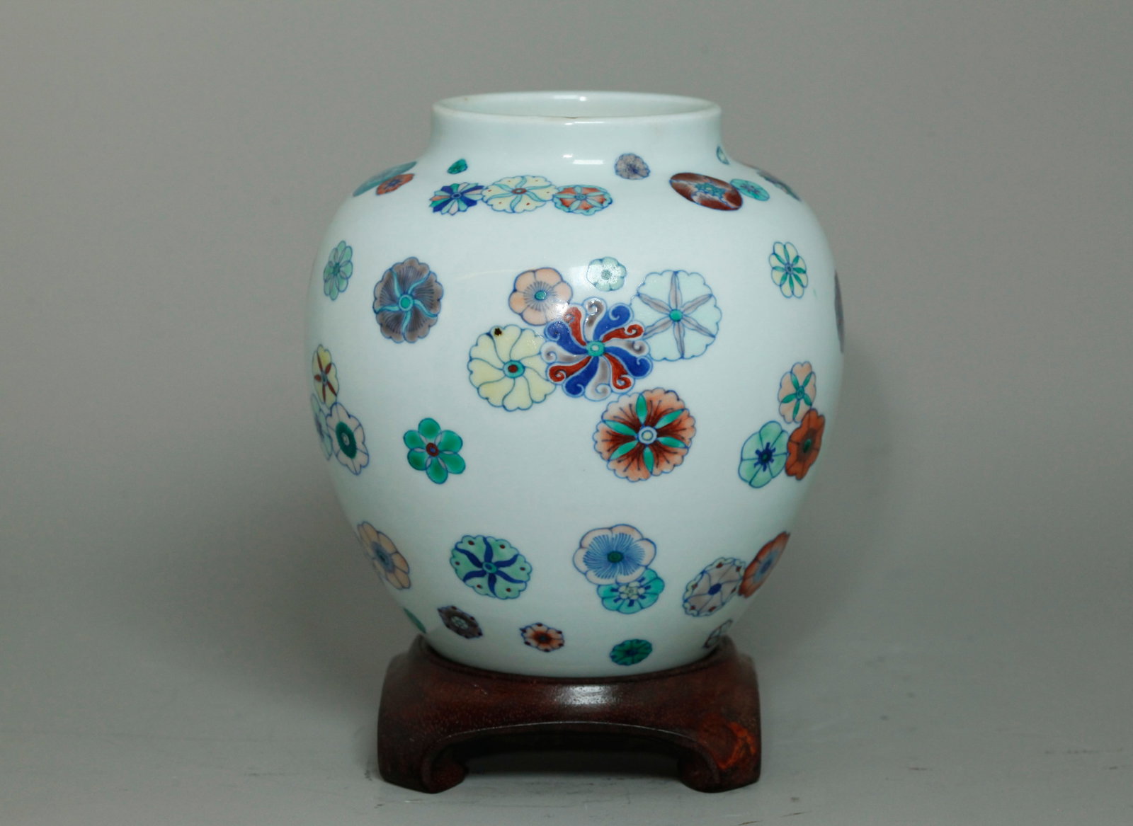 Fine Chinese Doucai Porcelain Ball-Flower Vase: Fine Chinese Porcelain lantern-shaped Vase in underglaze blue, carefully overglaze enameled in Doucai coloring with the "Ball Flower" pattern, the recessed base in clear glaze; wood stand. Height 6 1/
