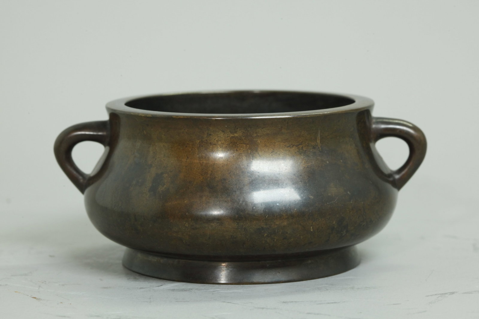 Chinese Round Bronze Censer With 2 Loop Handles: Chinese 19th century Round Bronze Censer With 2 tapered Loop Handles, the recessed base inside a slightly flared foot ring with 6 character seal mark. Weight 850 grams. Height 2 1/4 inches X diameter 