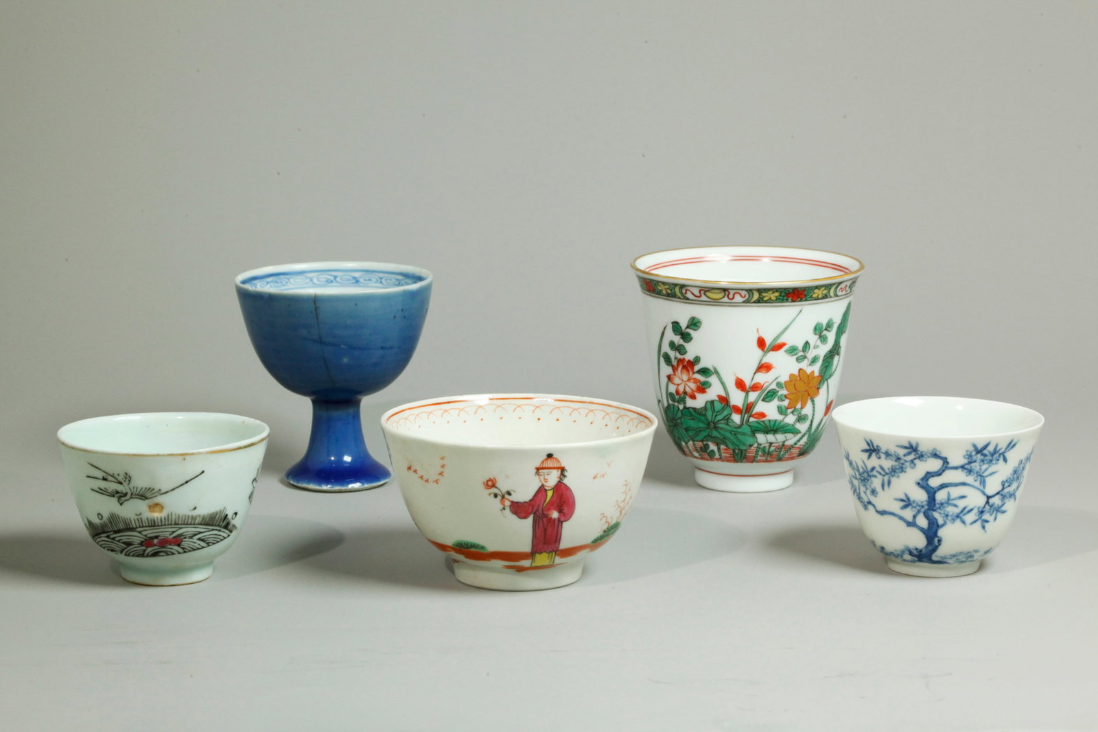 3 Chinese Porcelain Cups; 2 European Cups: 3 Chinese Porcelain Cups, a small "Month" cup in underglaze blue painting with blossoming tree and calligraphy with a 6 character Kangxi mark to base inside double rings all in underglaze blue, a smal