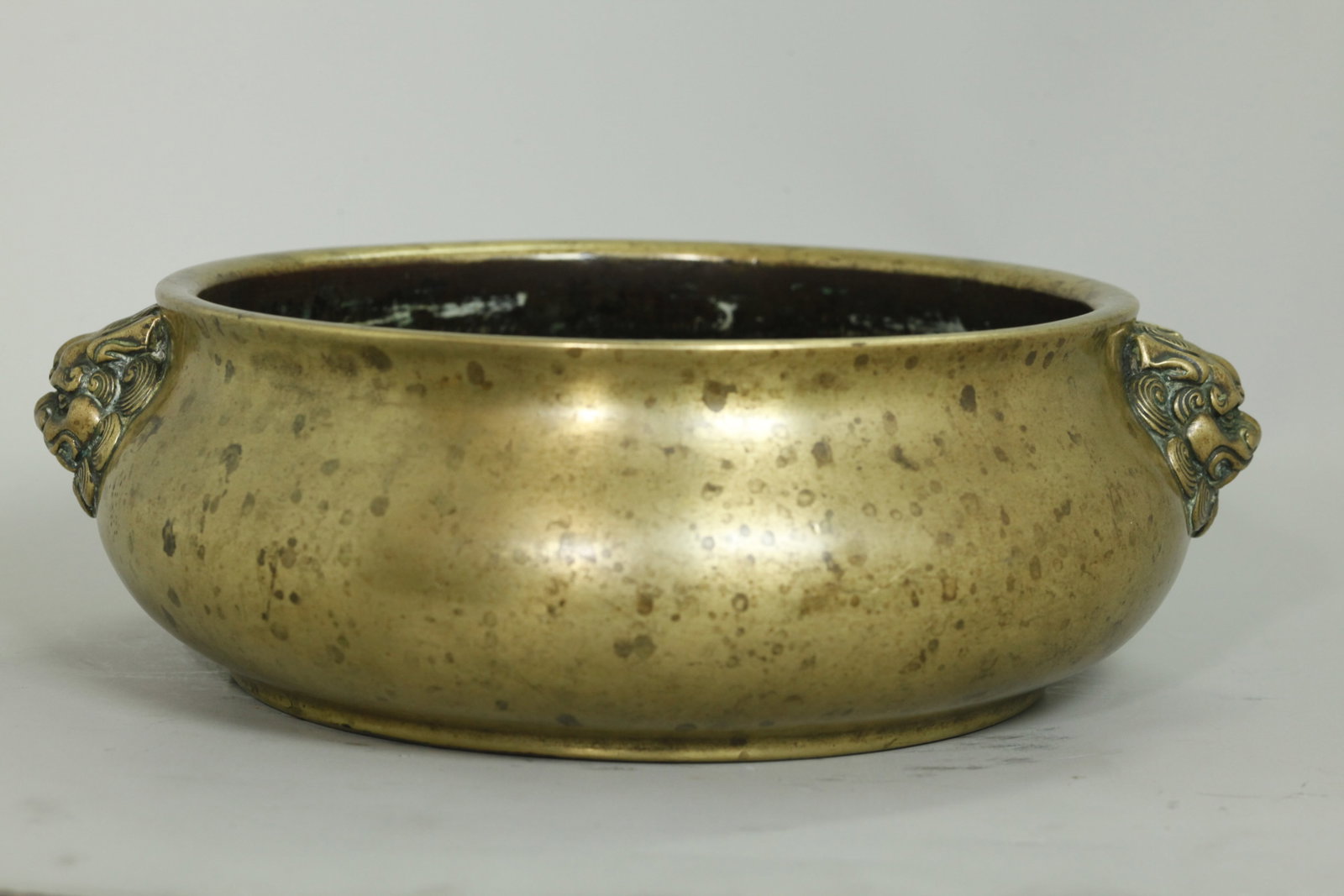 Chinese 18th C Heavy Bronze Lion Head Round Censer: Chinese 18th century Heavy Bronze Round Censer with large cast Lion Head Handles to the sides, the slightly recessed base with cast 6 character Xuande Seal Mark in recessed rectangle to center. Weight