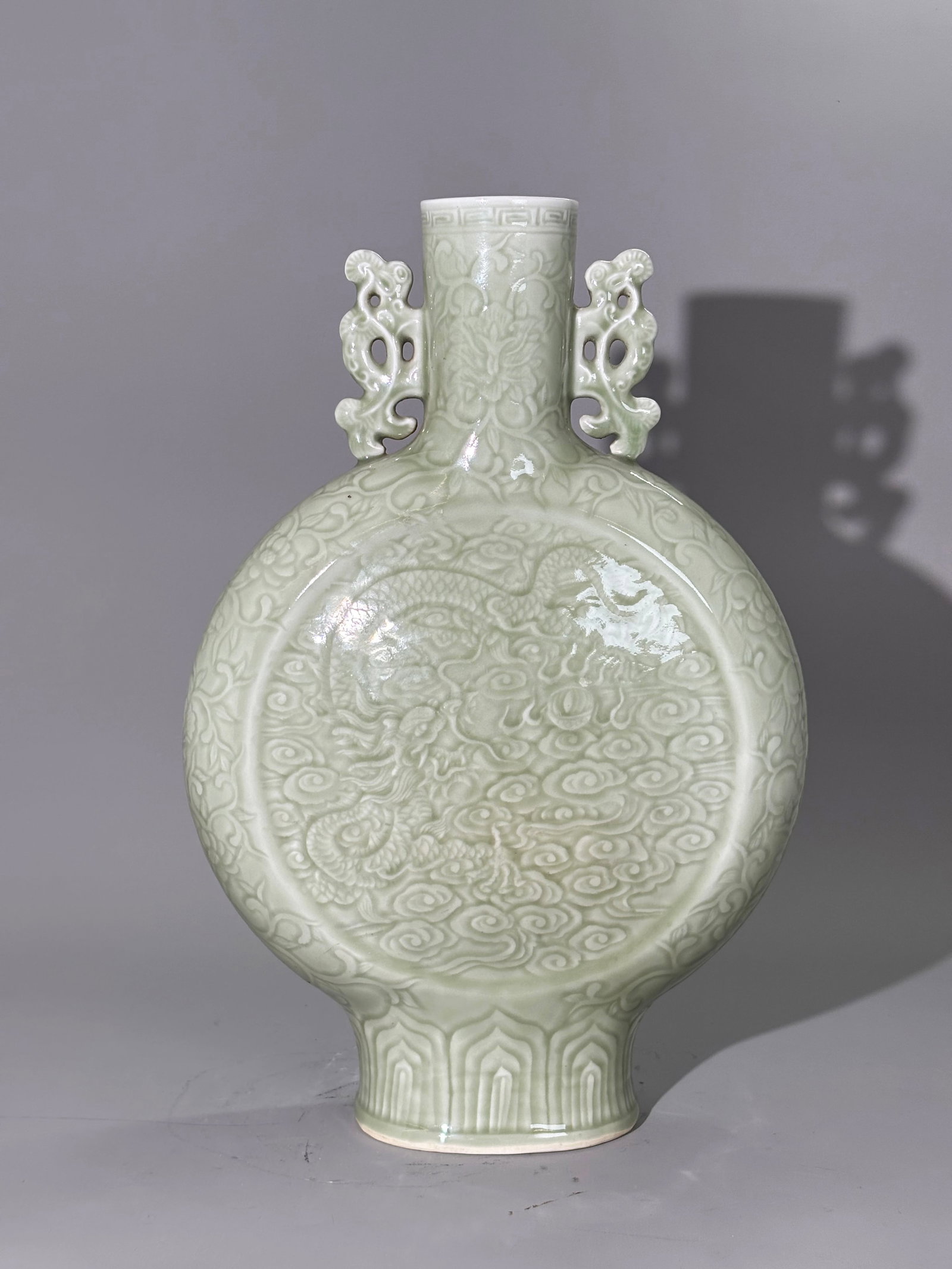 Lg Chinese Carved Celadon Porcelain Moon Flask: Fine Large Chinese bubble suffused Carved Celadon Porcelain Moon Flask with applied pierced handles to the round tubular neck, the front with a single 5-claw Dragon and Flaming Pearl in Clouds and the