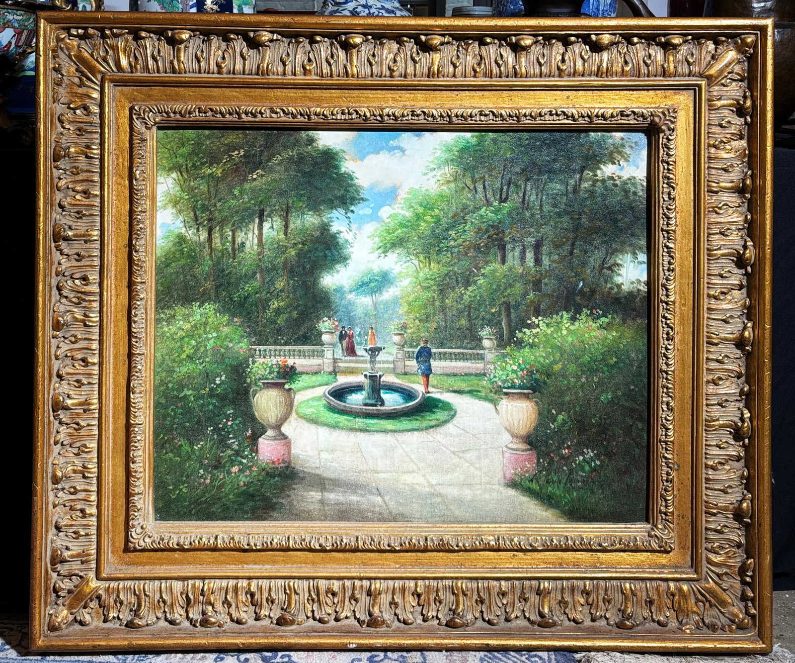 Park Scene; Oil on Canvas; Elaborate Gilt Frame: Park Scene with Figures and a Fountain; Oil on Canvas inscribed illegibly to lower right corner; Elaborate Gilt Frame. Height of art 24 inches X width 30 inches.