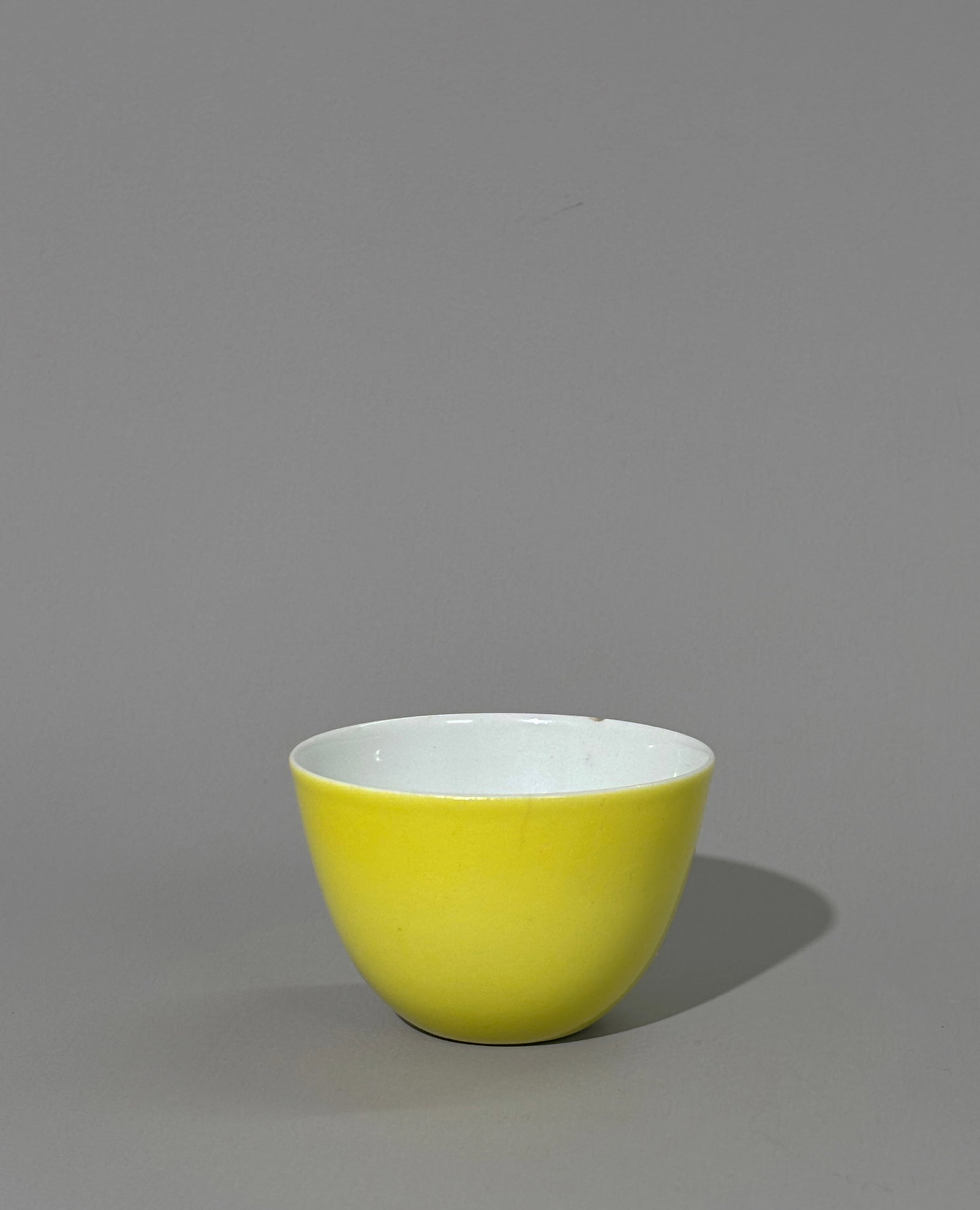 Chinese Lemon Yellow Enameled Porcelain Cup: Chinese Lemon Yellow Enameled near-eggshell Porcelain Cup with clear glaze to inside and to slightly recessed base with 6 character Qianlong seal mark in light underglaze blue to center. Height 1 5/8 