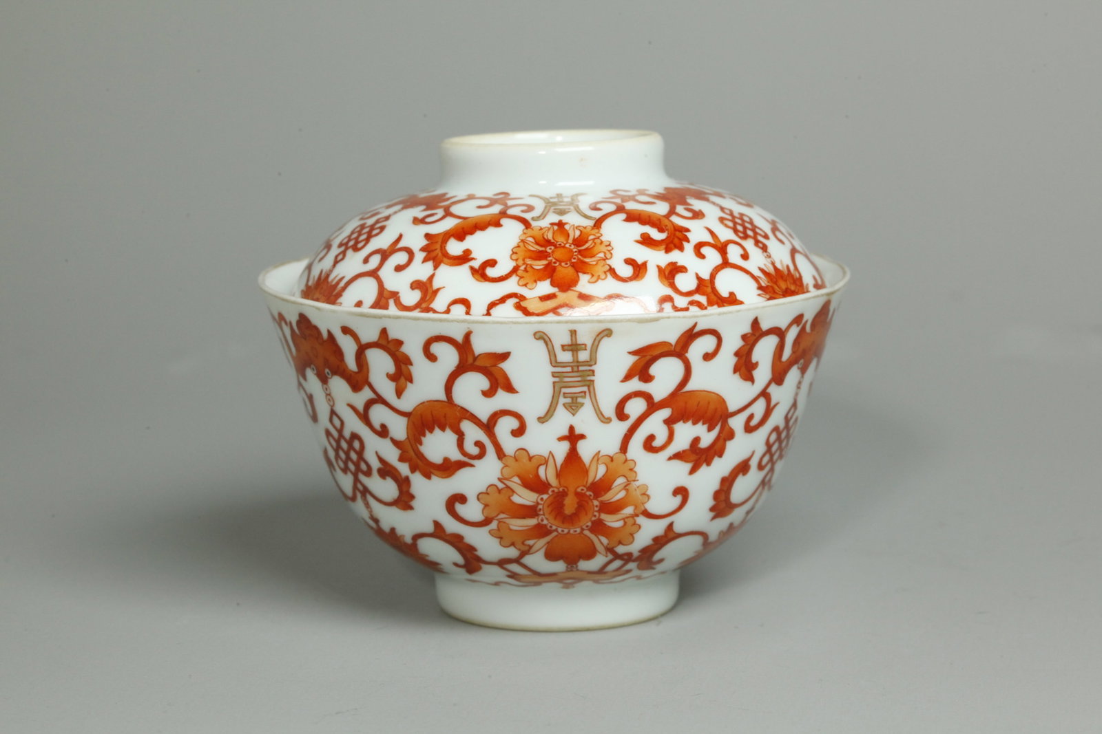 Chinese Daoguang Gaiwan Porcelain Teacup & Cover: Chinese Gaiwan Porcelain Teacup & Cover with a well enameled design of Shou, Descending Bats, Endless Knots and scrolling flowers in gold & iron red, the recessed base and cover grip in clear glaze ea