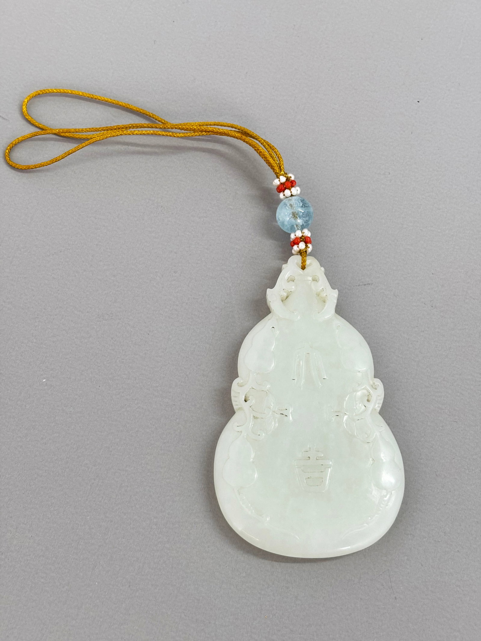 Chinese Warm White Jade Da Ji Double Gourd Pendant: Chinese Warm White Jade Da Ji Double Gourd Pendant carved in low relief with further double gourds & vines with flowers to the sides, a small hole to stem for suspension now with double yellow cords w