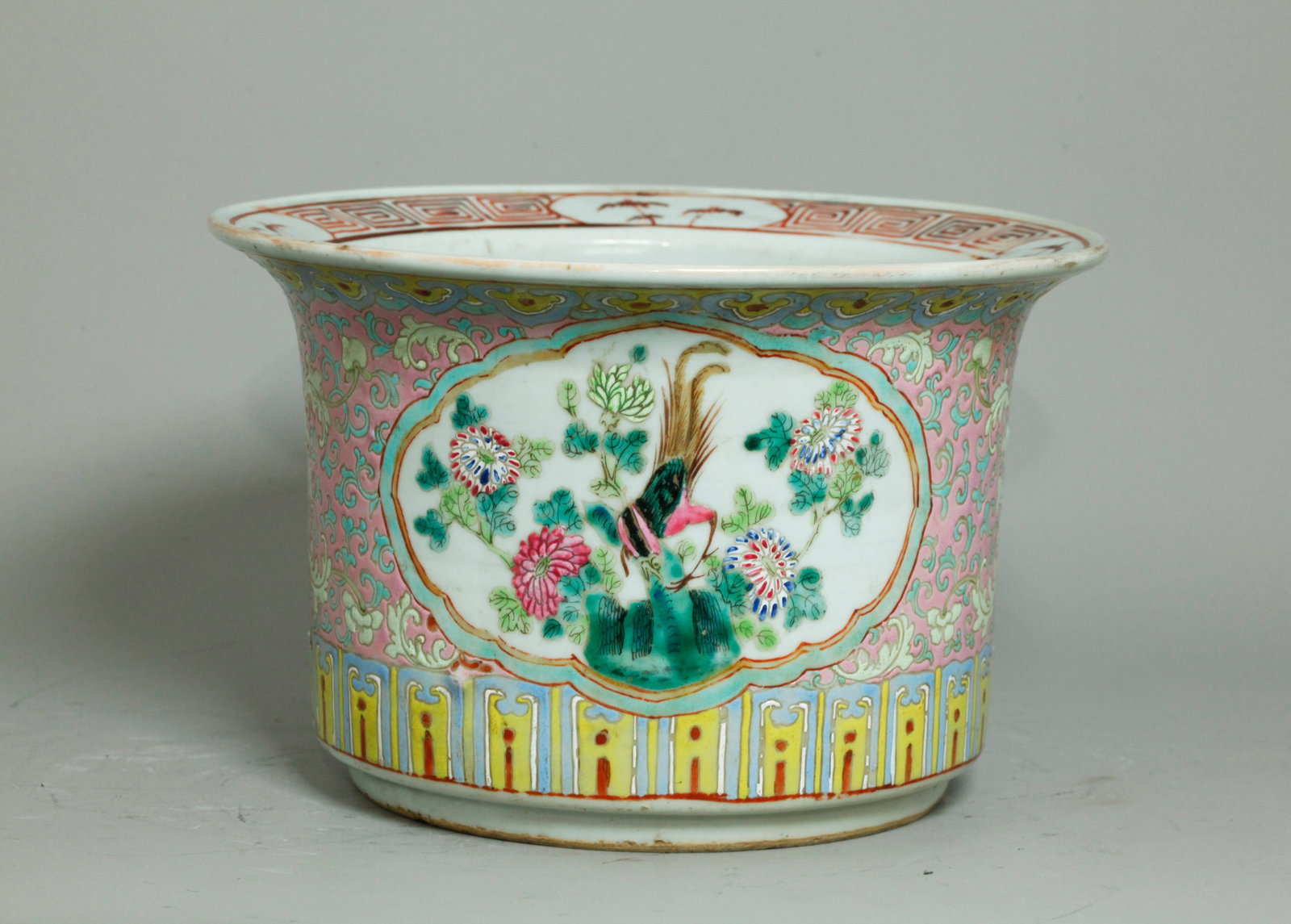 Chinese Late Qing Enameled Porcelain Planter: Chinese Late Qing Enameled Porcelain Planter with a quatrefoil window front and back enameled with exotic birds and garden flowers on a pink & turquoise ground between pale blue and yellow borders, th