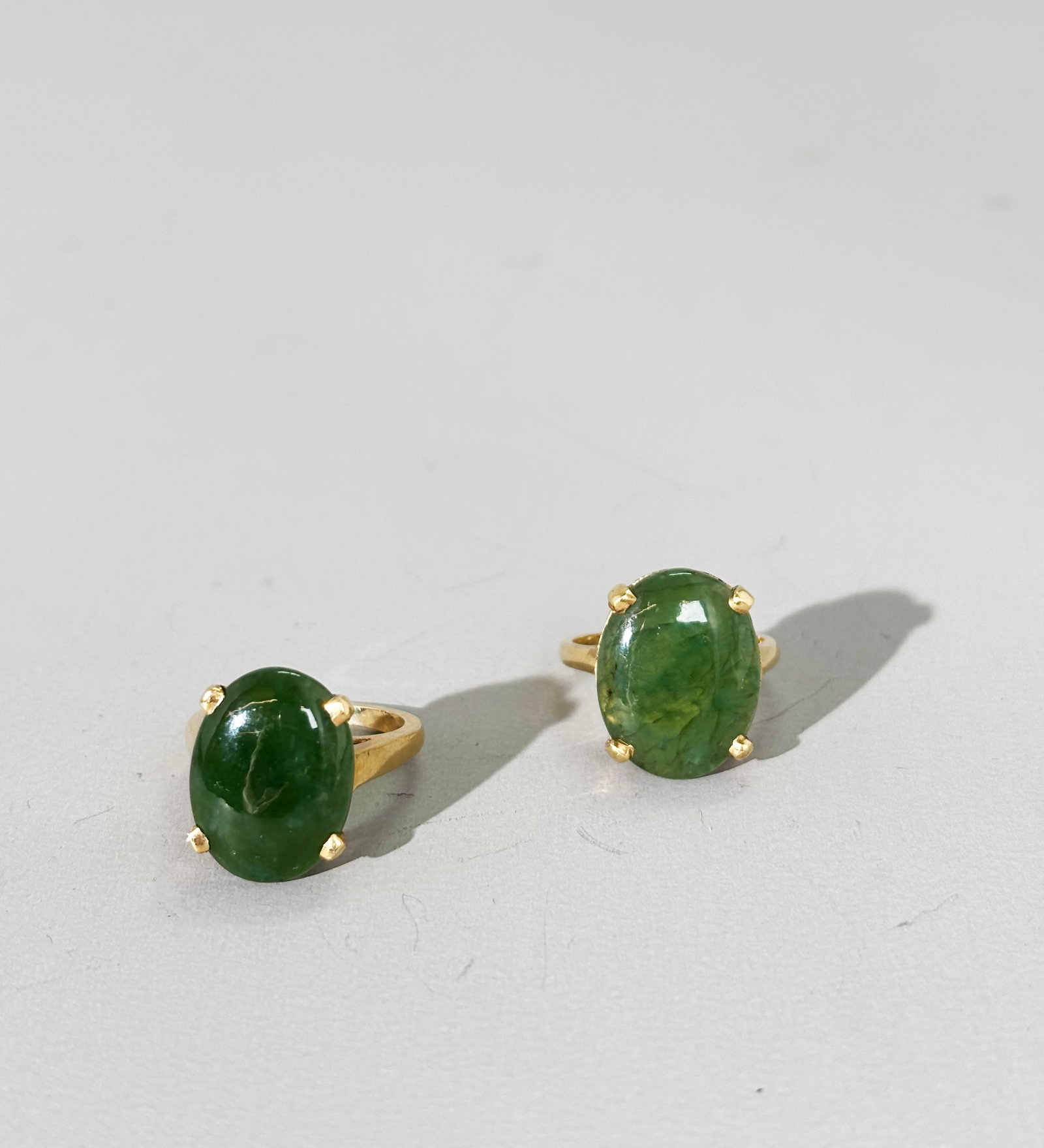 2 Chinese Translucent Green Jade Cabochon 14K Ring: 2 Chinese Translucent Green Jade Cabochons each vintage prong set as rings in yellow gold marked "14K" inside the bands. US Ring size 6 1/4 and US Ring size 6. Provenance: Property of a New York old C