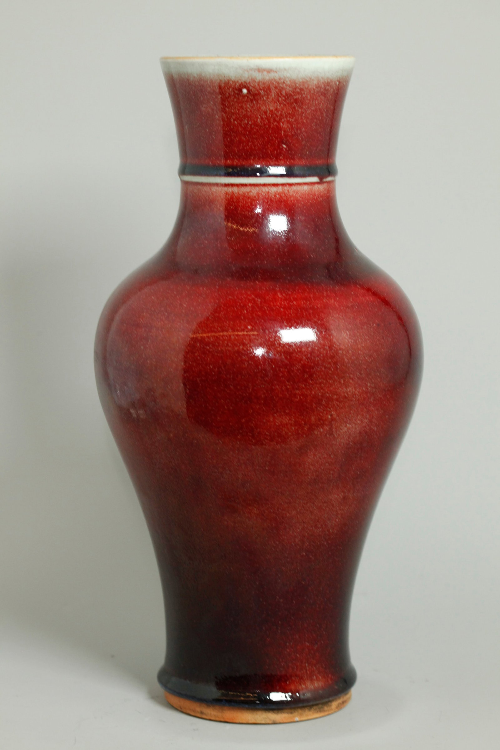 Chinese 19th Century Langyao Red Porcelain Vase: Chinese 19th Century Langyao underglaze Red Crackle Porcelain Vase, the thick bubble suffused glaze thinning at the mouth and neck ring to a pale celadon crackle and ending before the unglazed foot wi