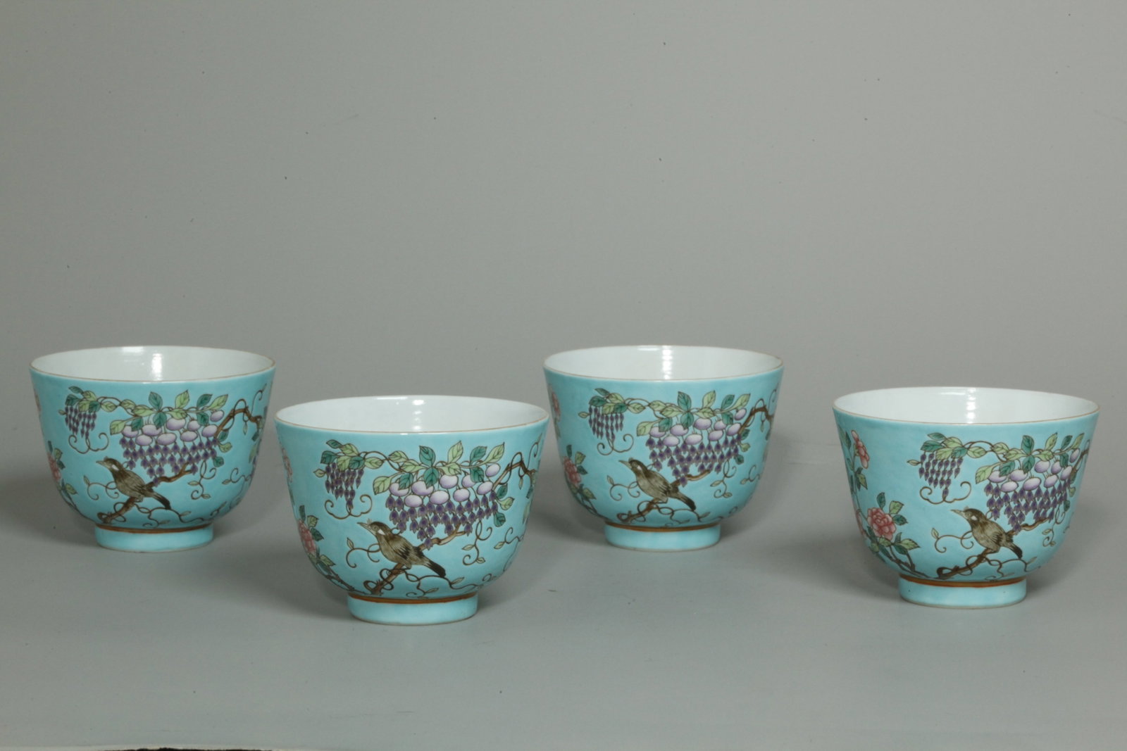 4 Chinese Qing Da Ya Zhai Turquoise Porcelain Cups: 4 Chinese Late Qing Dynasty "Da Ya Zhai type" Enameled Porcelain Cups with an outside design of a black bird on Garden Branch with flowering Wisteria Vines and Rose branches all on a turquoise enamel 