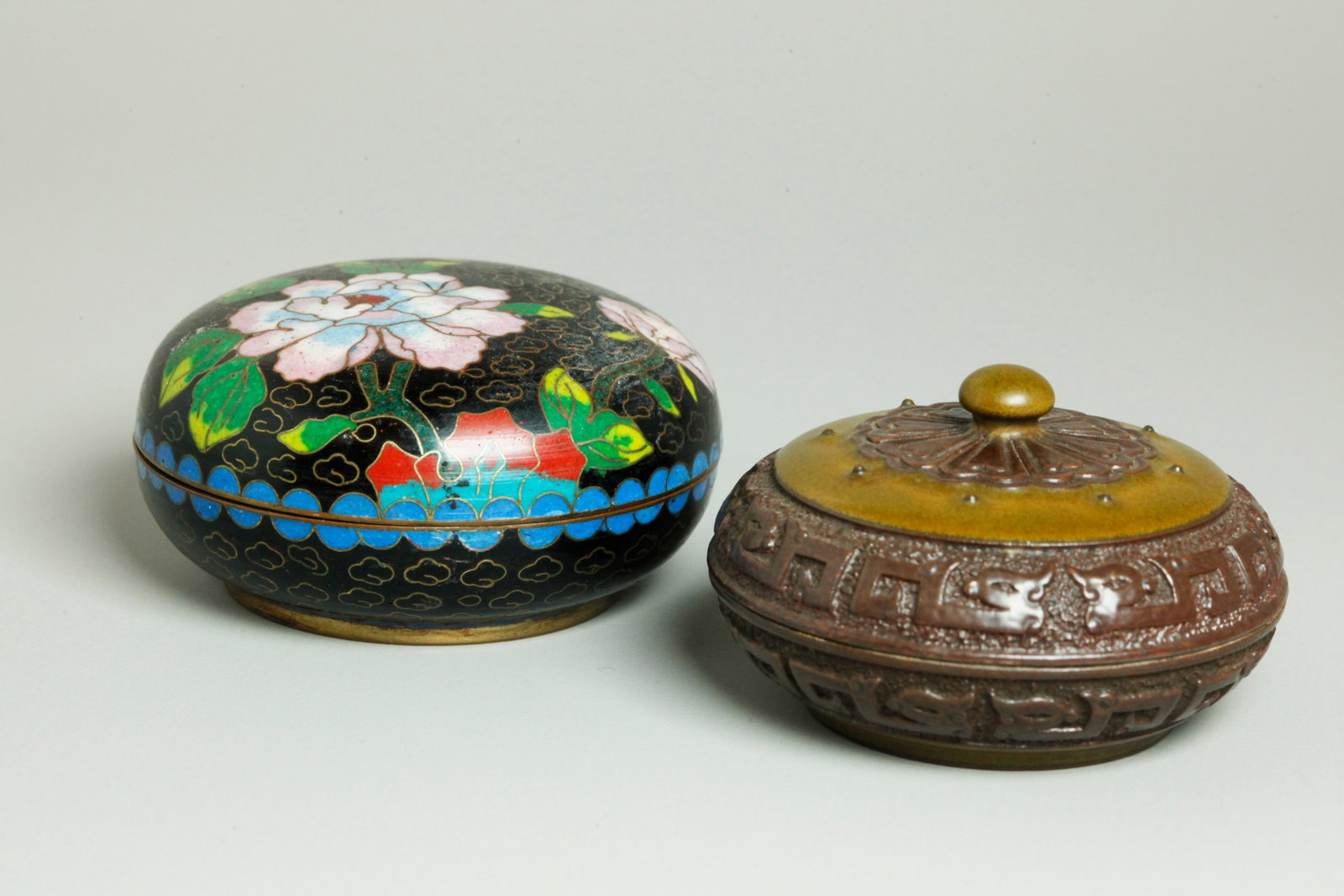 2 Chinese Seal Paste Boxes Porcelain & Cloisonne: 2 Chinese Seal Paste Round Boxes: 1 Porcelain box finely carved with archaistic double Dragon curls, a flower petal center to top with button finial and 4 character Qianlong seal mark to base, partial
