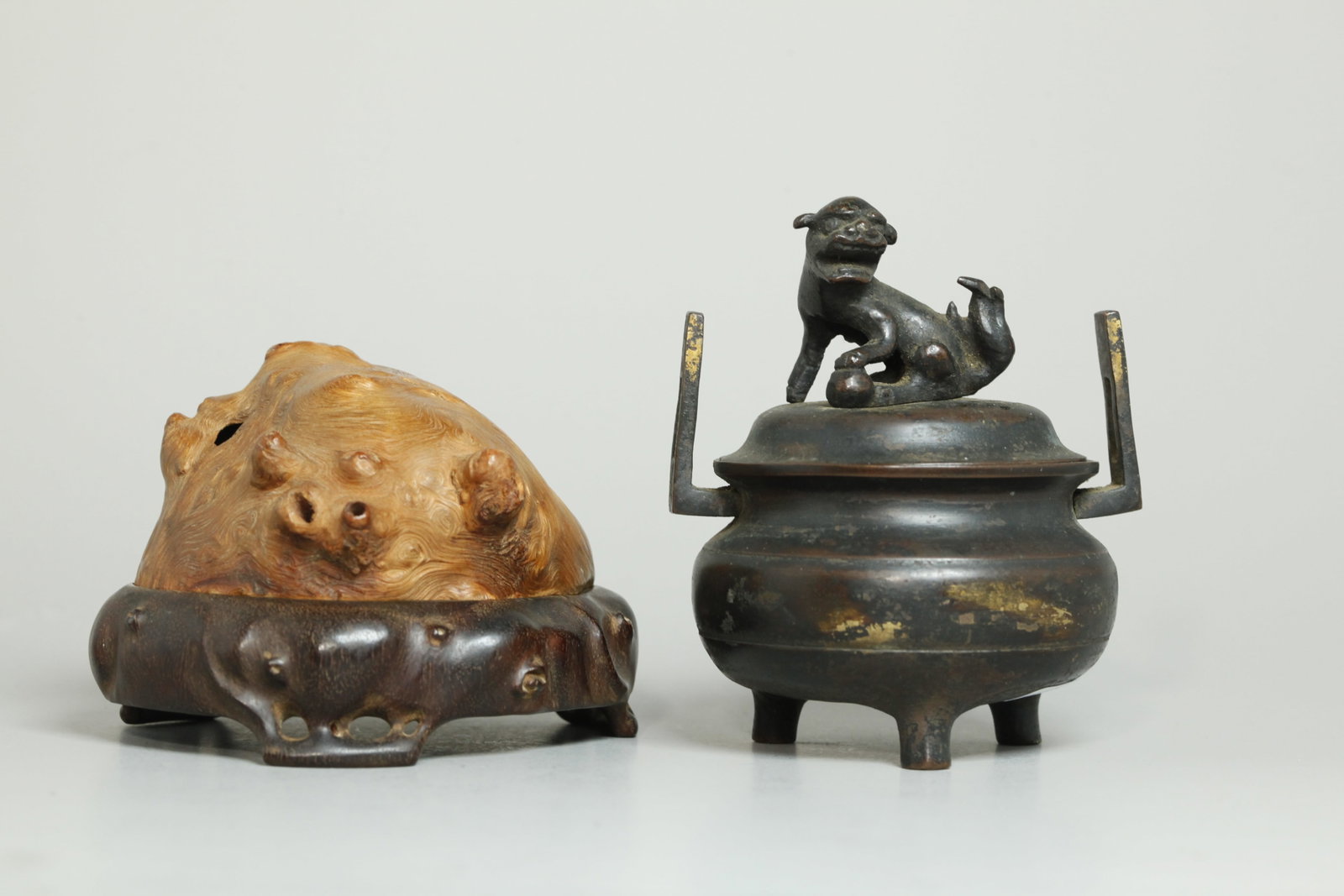 2 Sm Chinese Bronze Censer; Huamu Hard Wood: Small Chinese Bronze Censer on 3 feet with 2 handles and pierced cover with Fu Dog & Ball Finial with splashes of gilding to sides; together with a hard wood box on 3 feet with a Huamu Burl Wood hollo