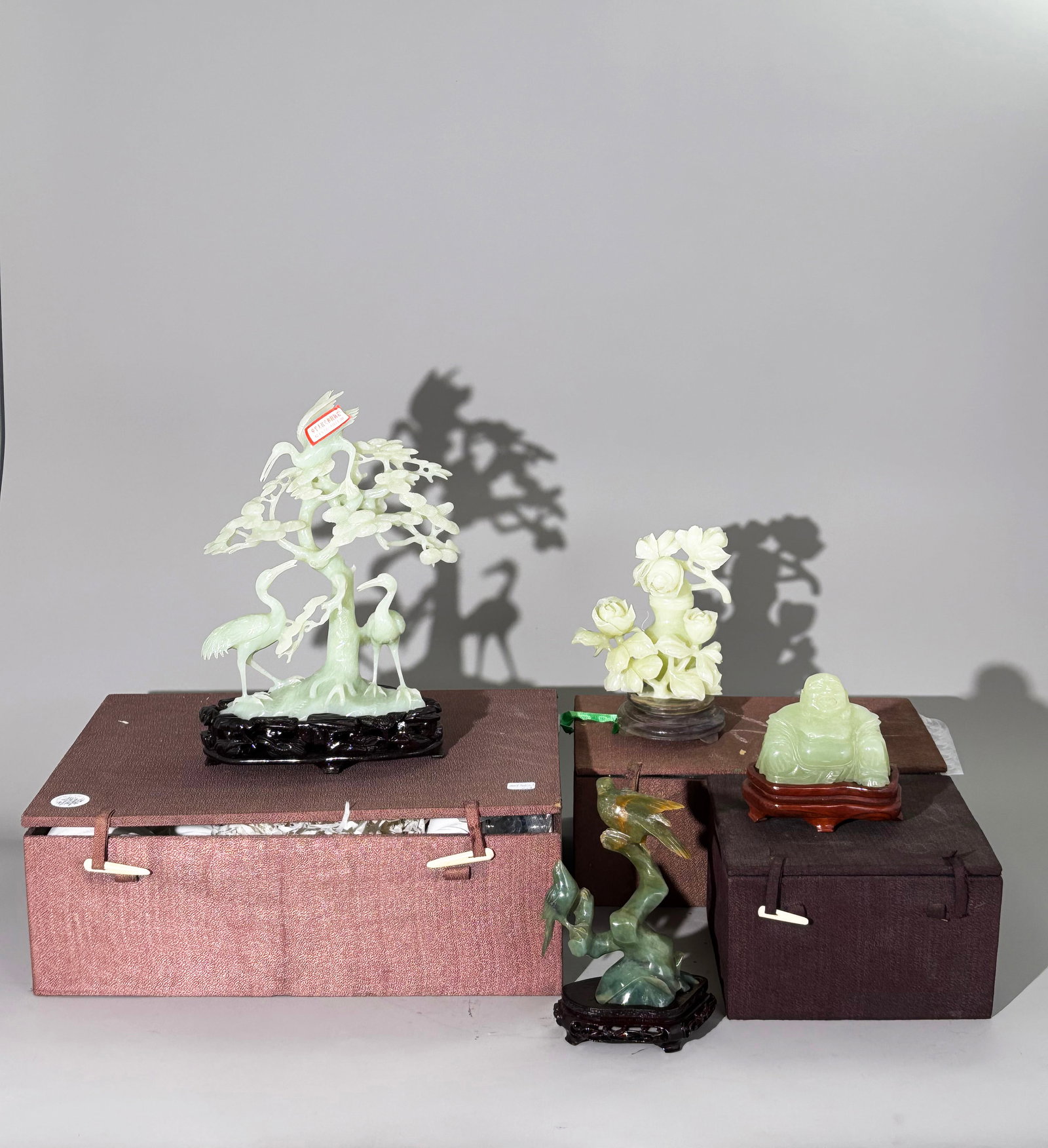 4 Chinese Polished Pale Celadon Carvings: 4 Good Chinese Polished Pale Celadon Carvings, probably in translucent Serpentine: the largest a Pine Tree with 3 long-life Cranes with carved wood stand and custom storage box; a polished, covered sm