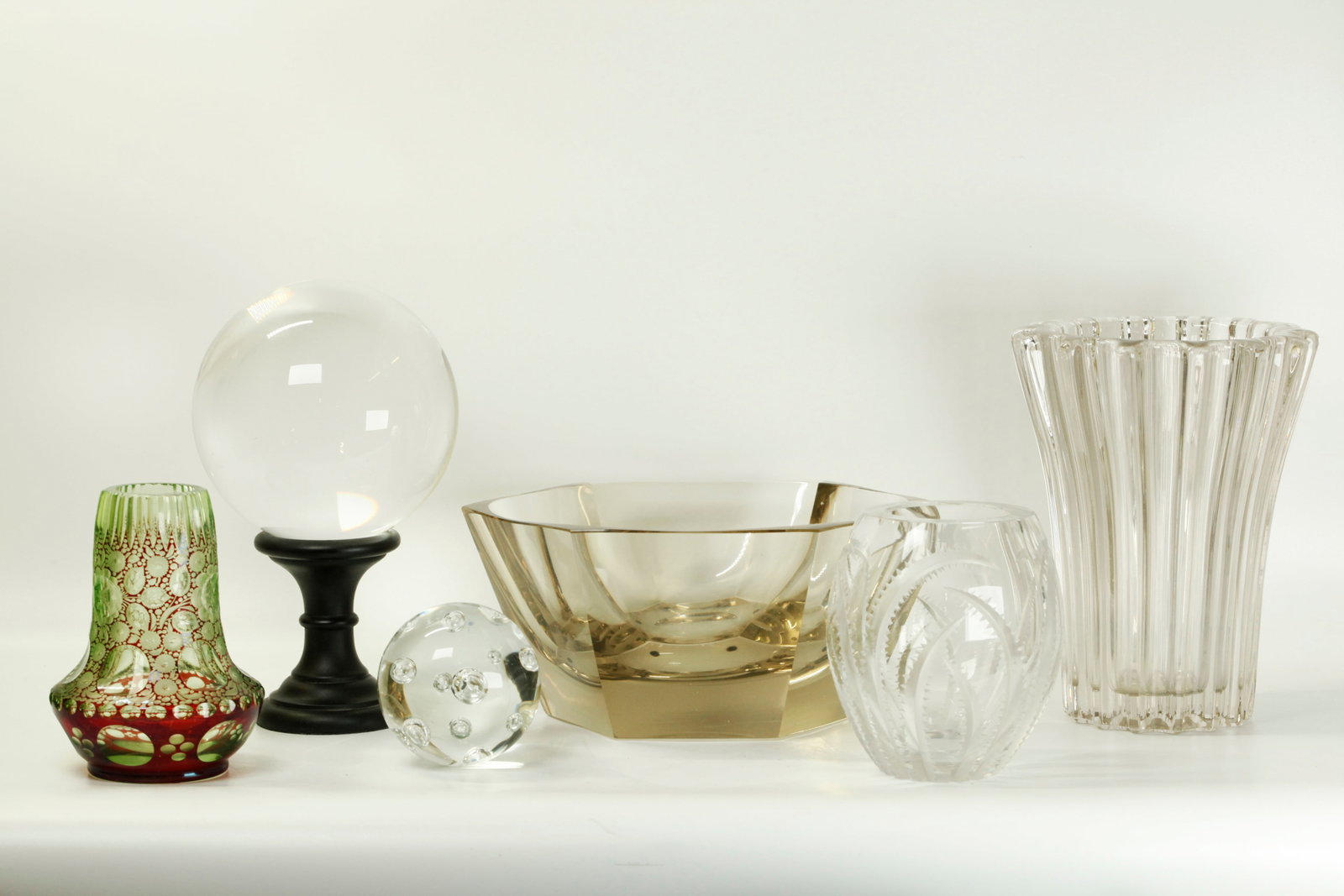 6 Art Deco to Mid Century Modern Cut Glass: 6 Good Cut Glass Decorations; a green and red Bohemian Jugendstil glass vase, 2 transparent glass Balls, 2 cut glass Vases and a heavy smoky glass centerpiece Bowl. Various sizes and various manufactu