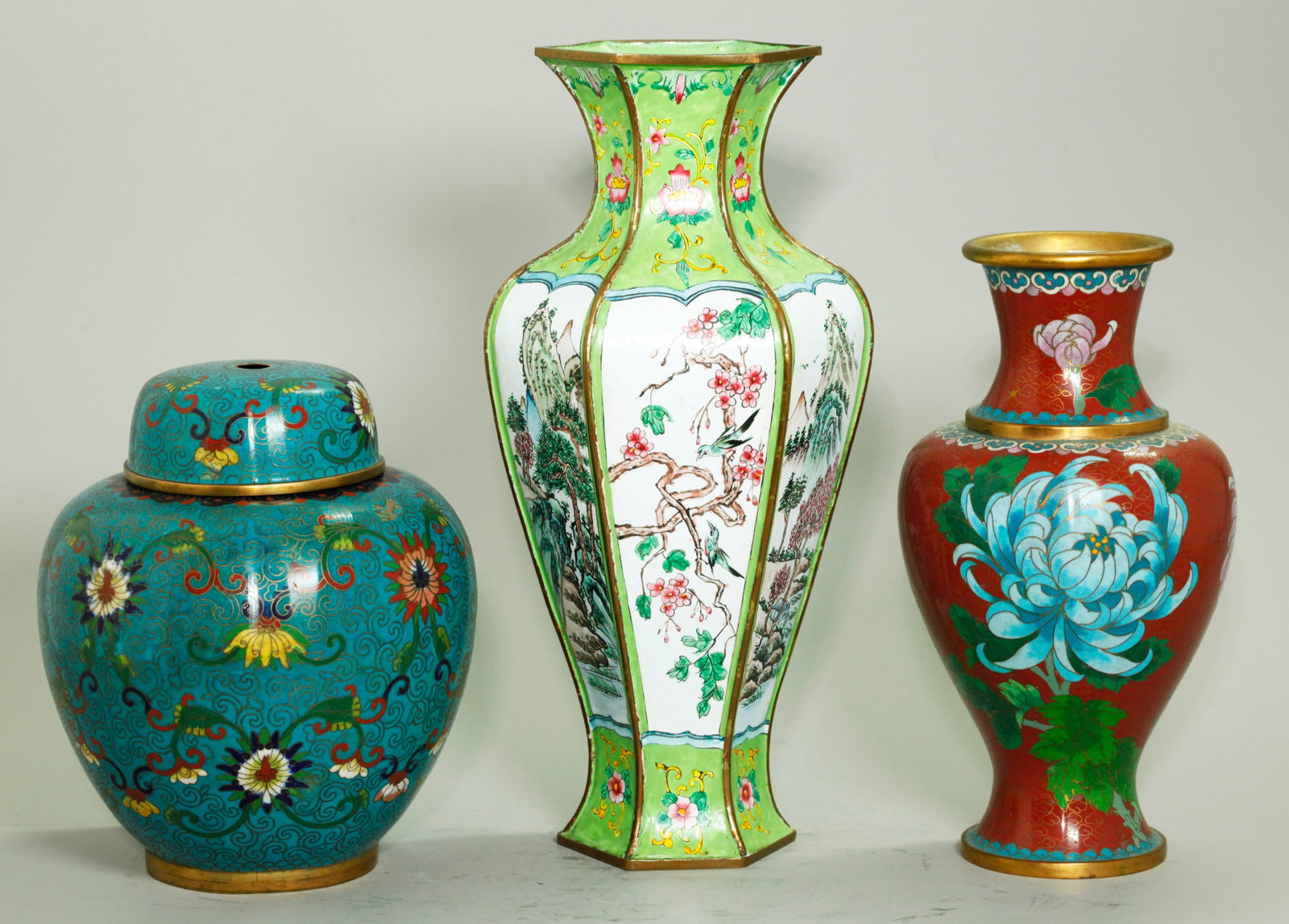 2 Chinese Cloisonne Vases; 1 Canton Enamel: 2 Chinese gilt bronze and Cloisonne pieces, a Ginger Jar & Cover with scrolling flowers on a light blue ground and a Vase with Chrysanthemums and a butterfly on a red ground with gilt cloud wires; tog